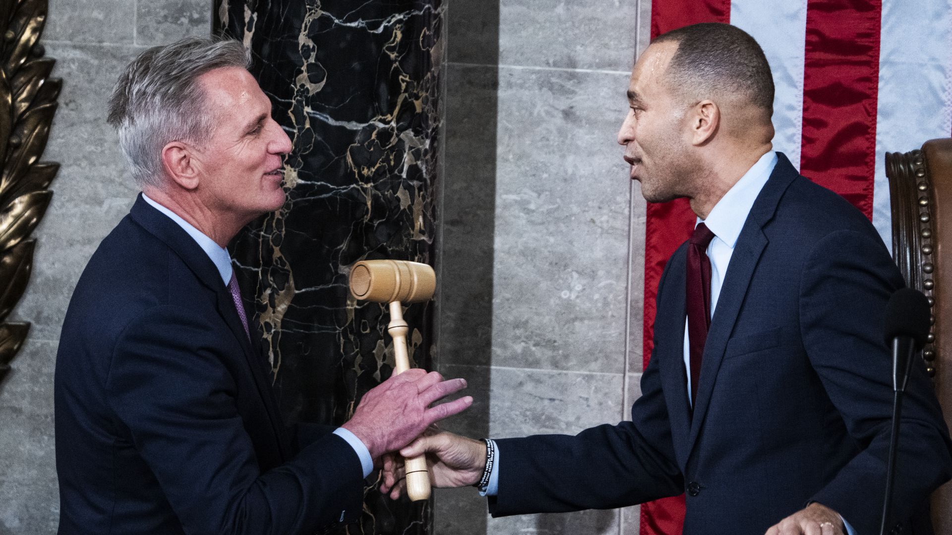 House Minority Leader Hakeem Jeffries hands the speaker's gavel to Speaker Kevin McCarthy in the House chamber.