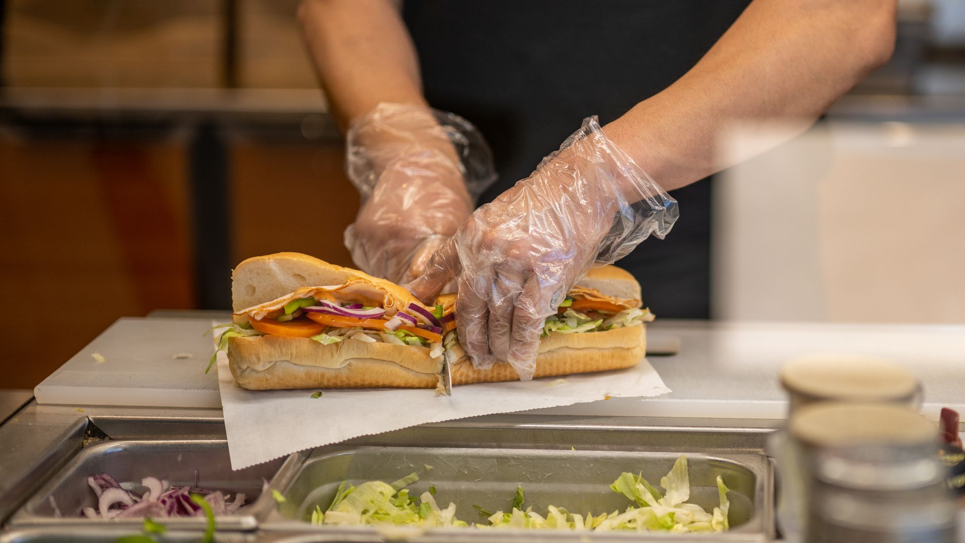 Footlong sandwich being cut in half