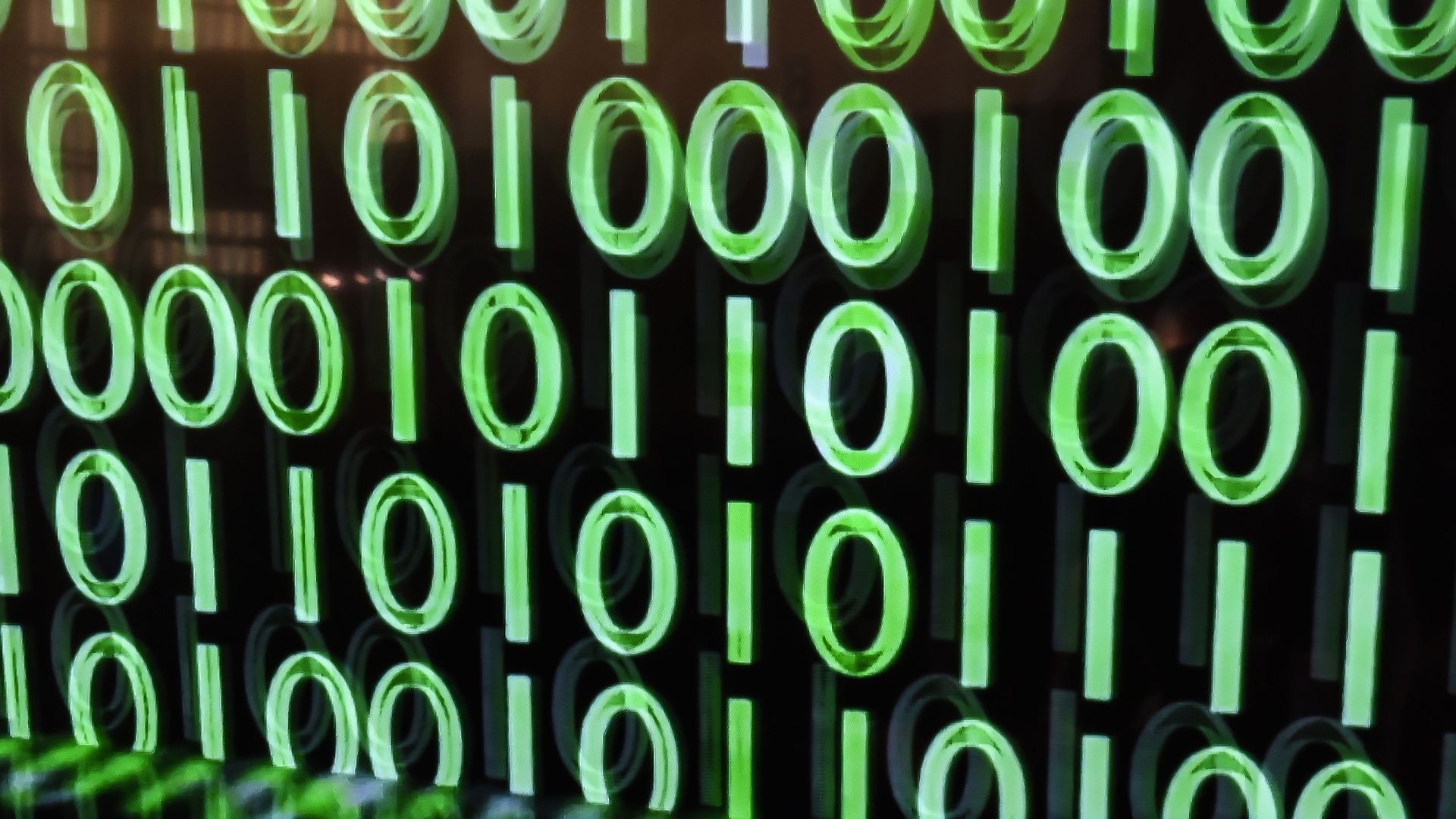 0s and 1s displayed in green on black computer screen