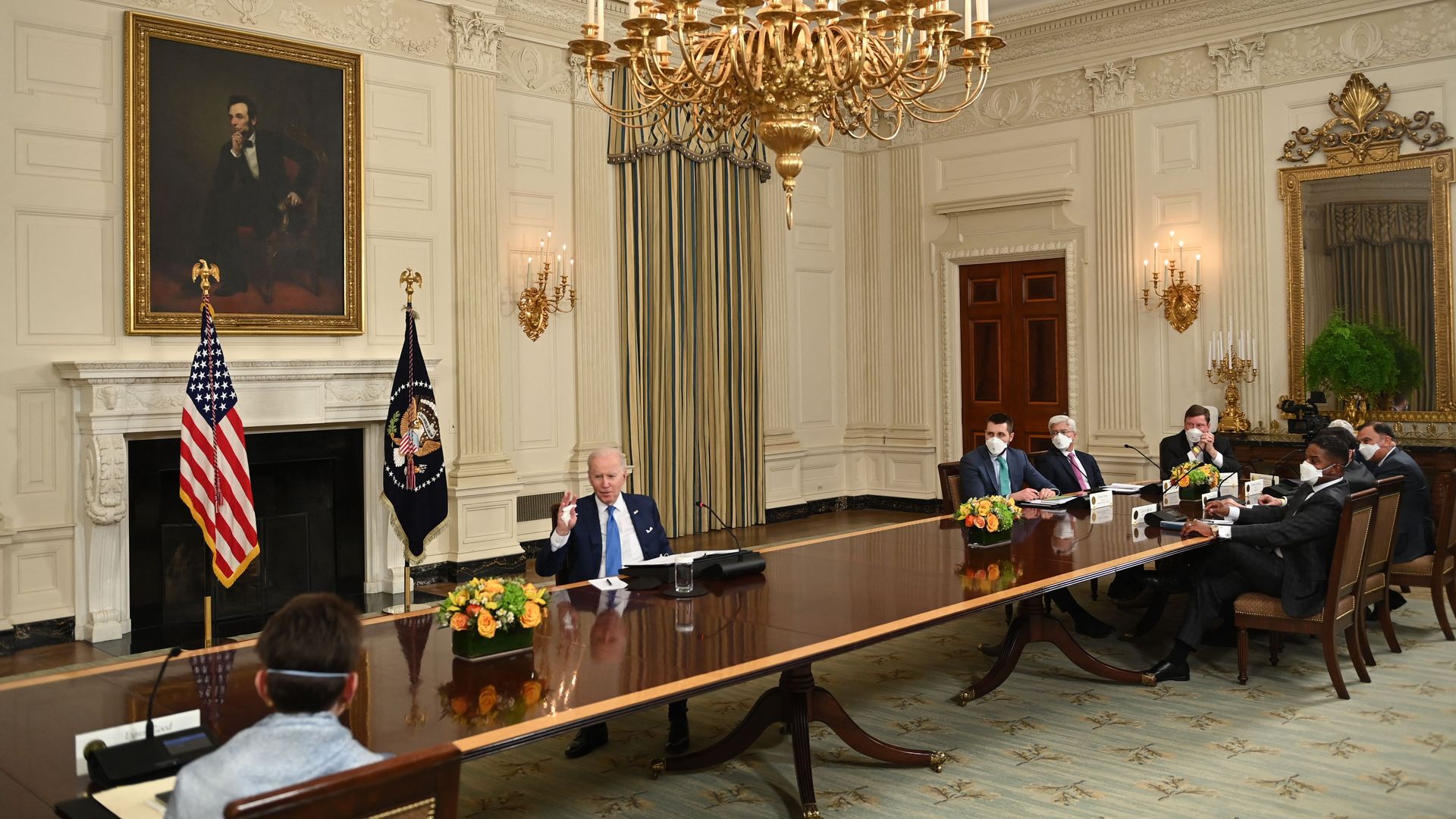 President Biden is seen sitting at a long table with oil executives.