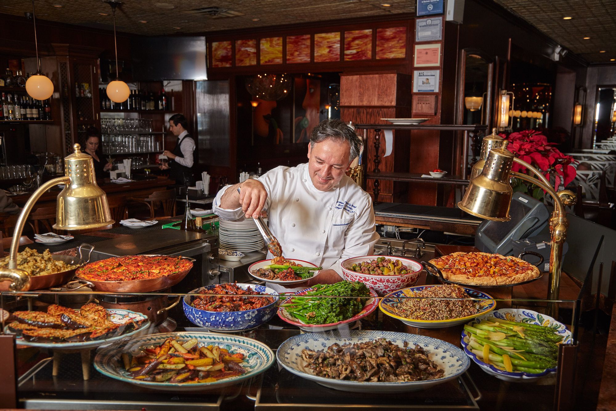 Cafe Fiorello's famous antipasti bar with a chef in a white jacket 