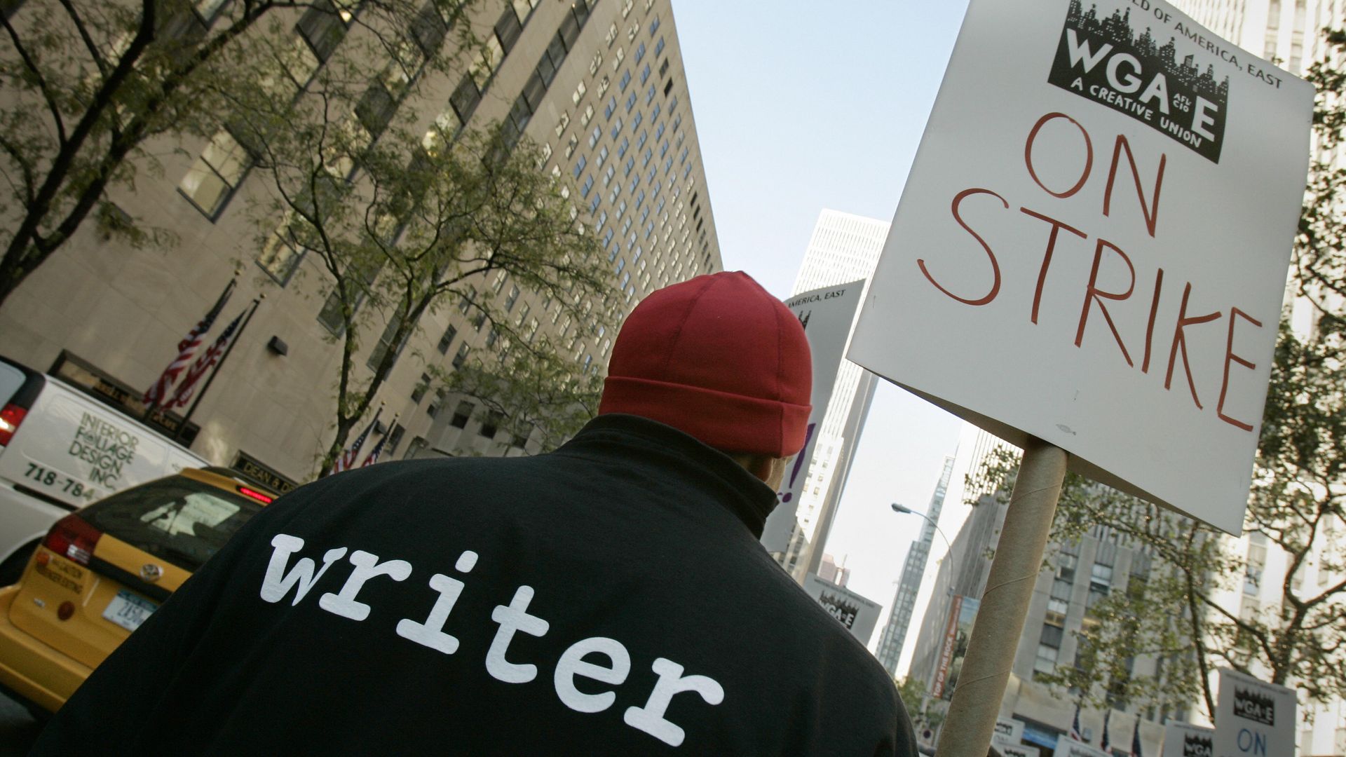 A man with "writer" printed on the back of a t-shirt joins members of the Writers Guild of America, East picket Rockefeller Center, the headquarters of NBC, 05 November 2007, in New York