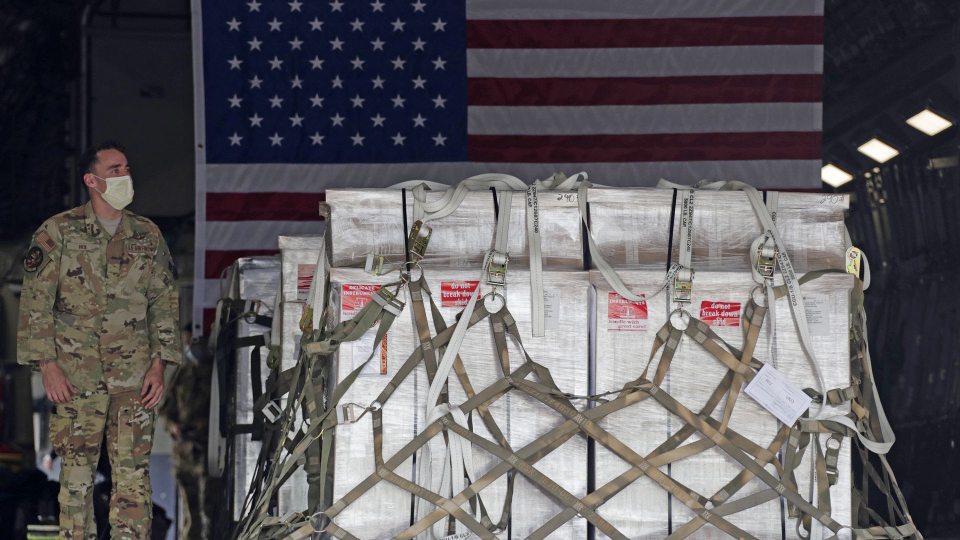 Soldier stands next to packages 