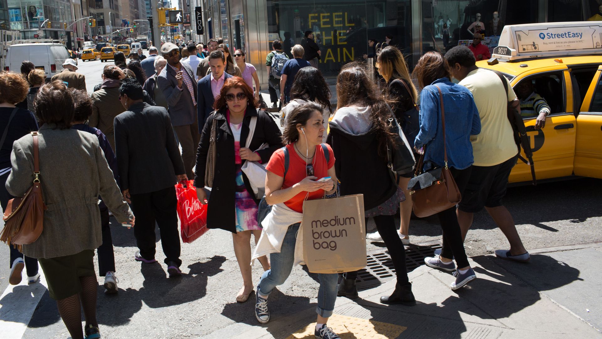 Shoppers walk through a crowded New York crosswalk