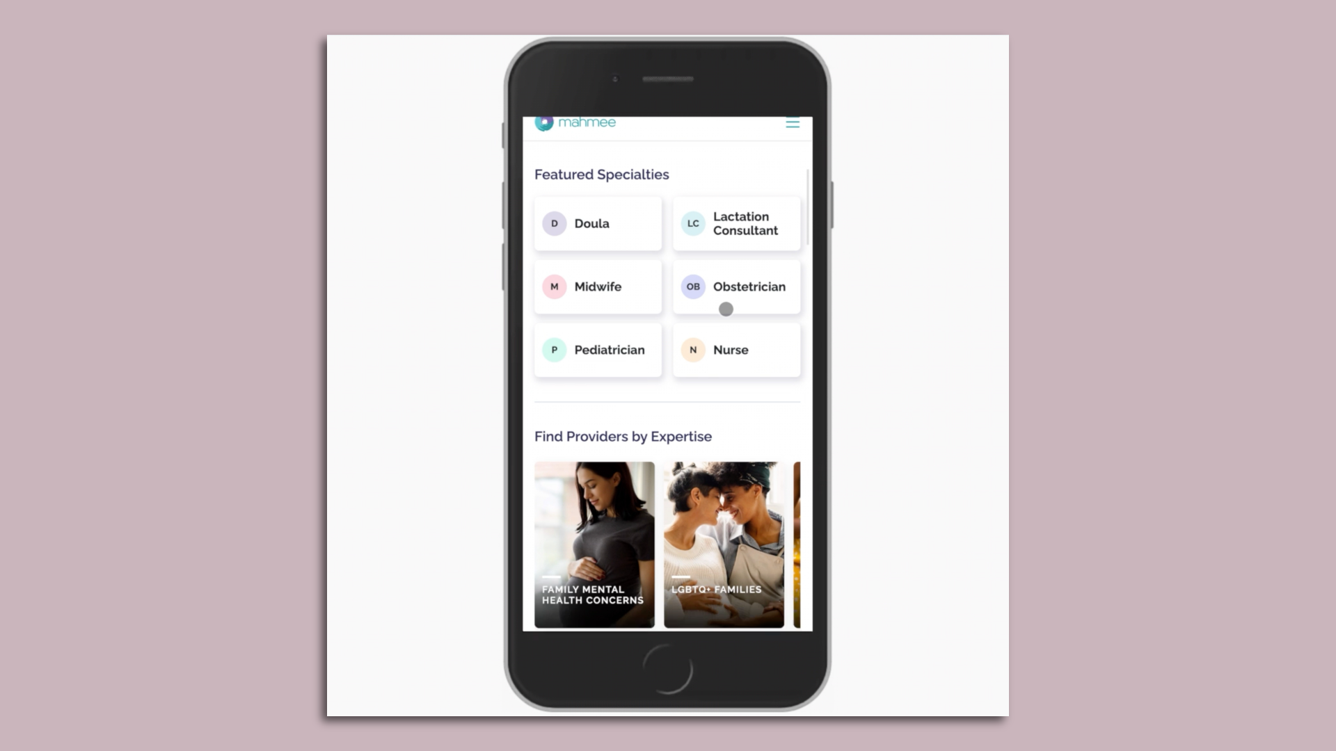 Photo of an iPhone showing the Mahmee app on its screen, including featured specialties like doula, nurse and etc.