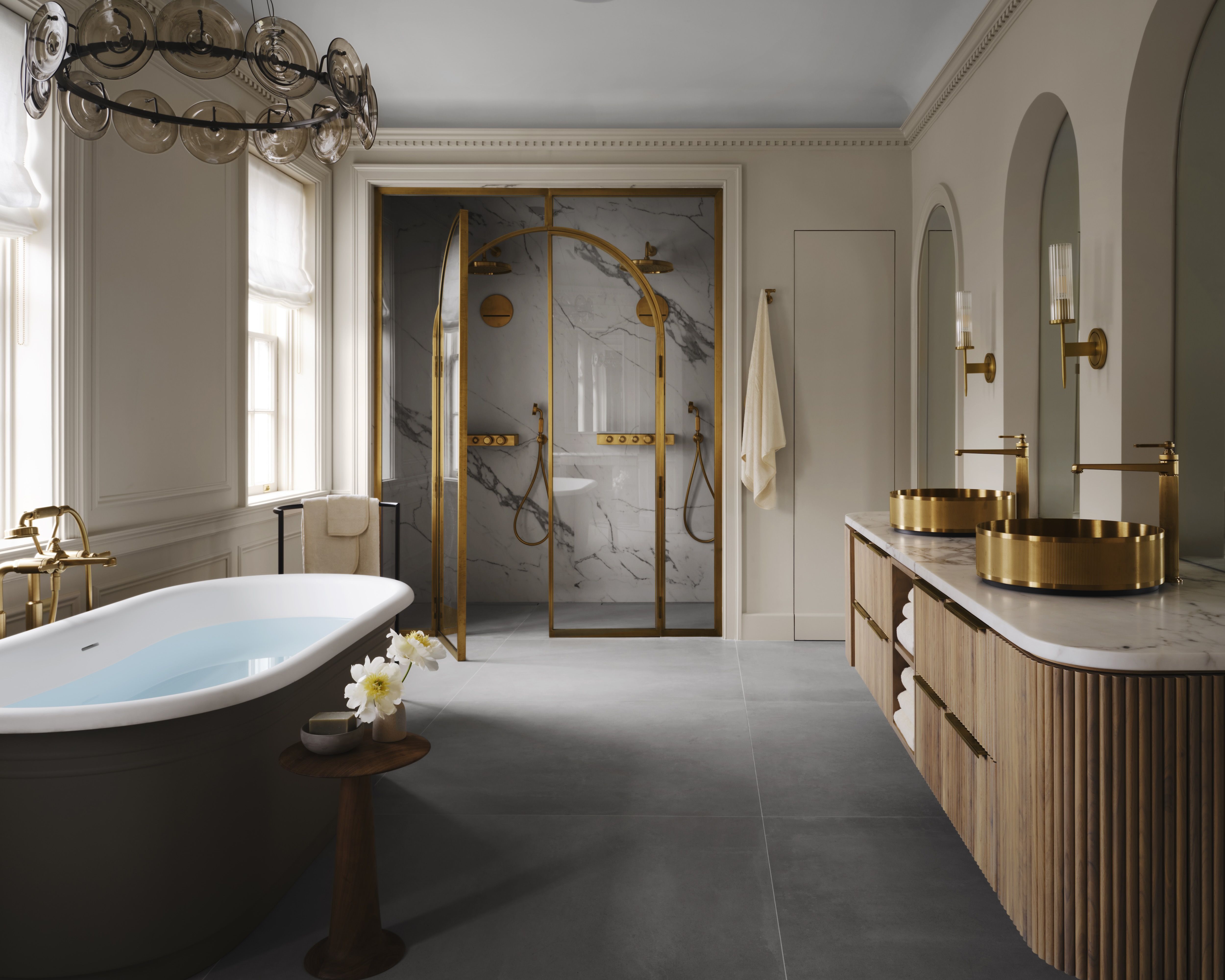 A photo showing a bathroom with a soaking tub and marble accents.