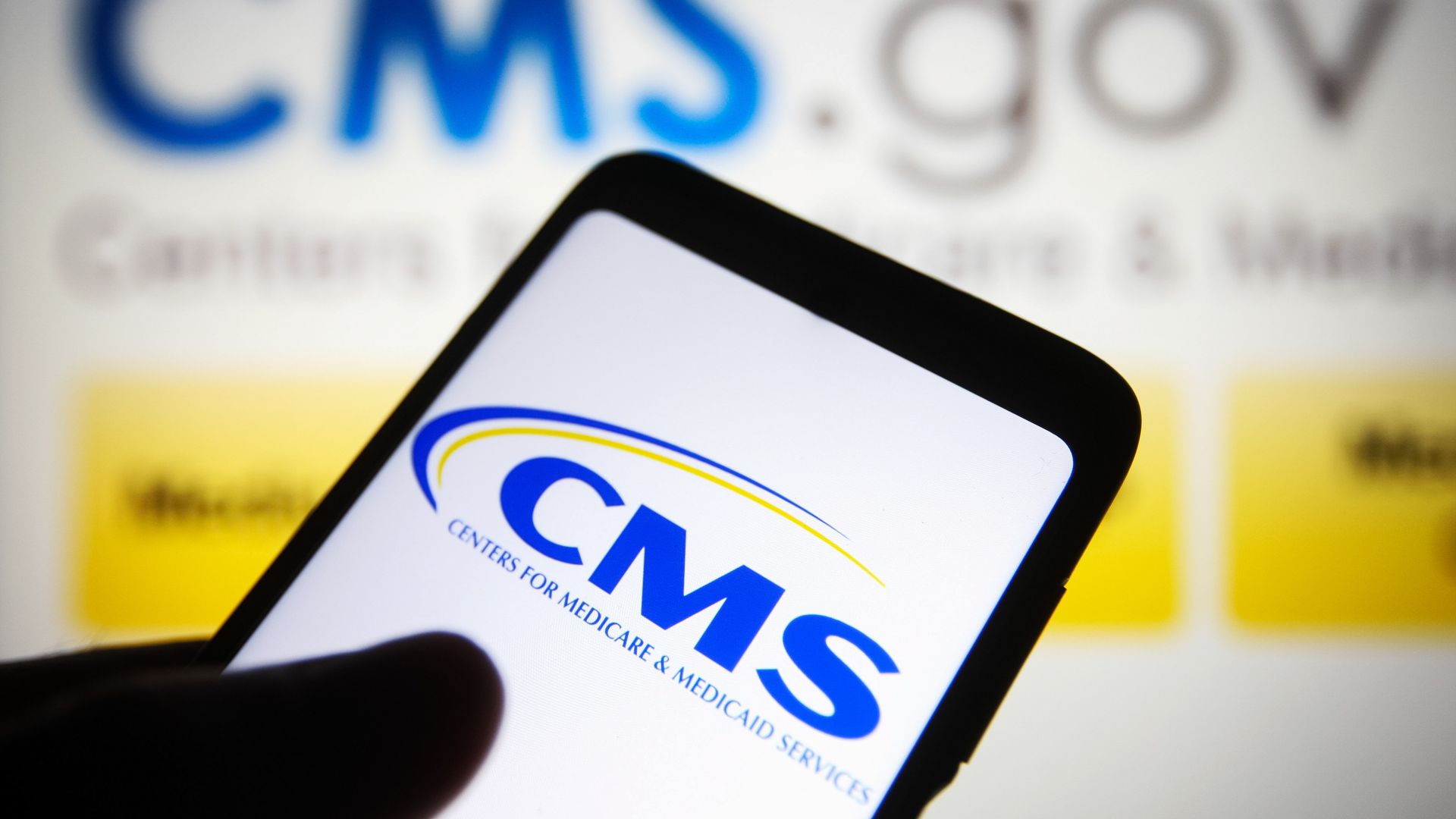 The CMS logo on a phone screen.