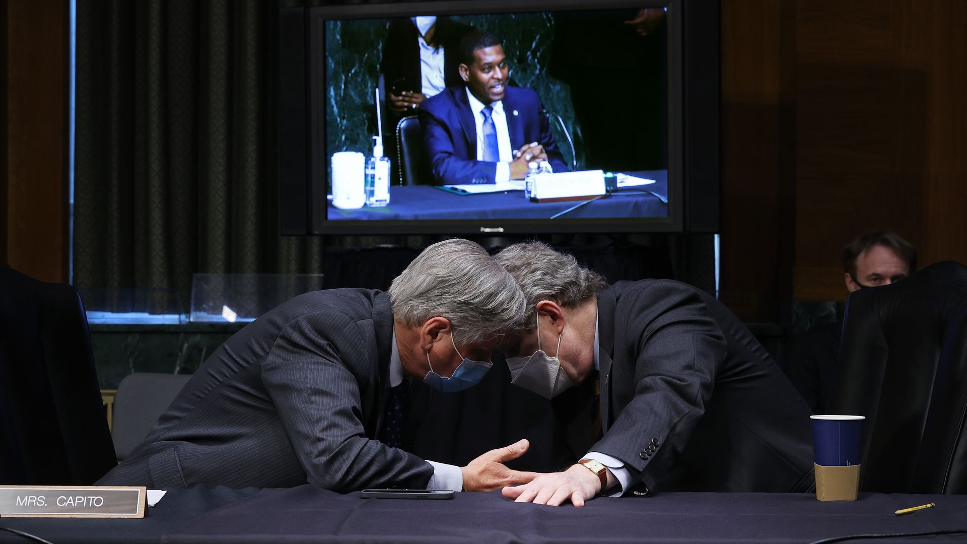 Sens. John Hoeven (R-N.D.) and Sen. John Kennedy (R-La.) are seen speaking during  a hearing with EPA Administrator Michael Regan.