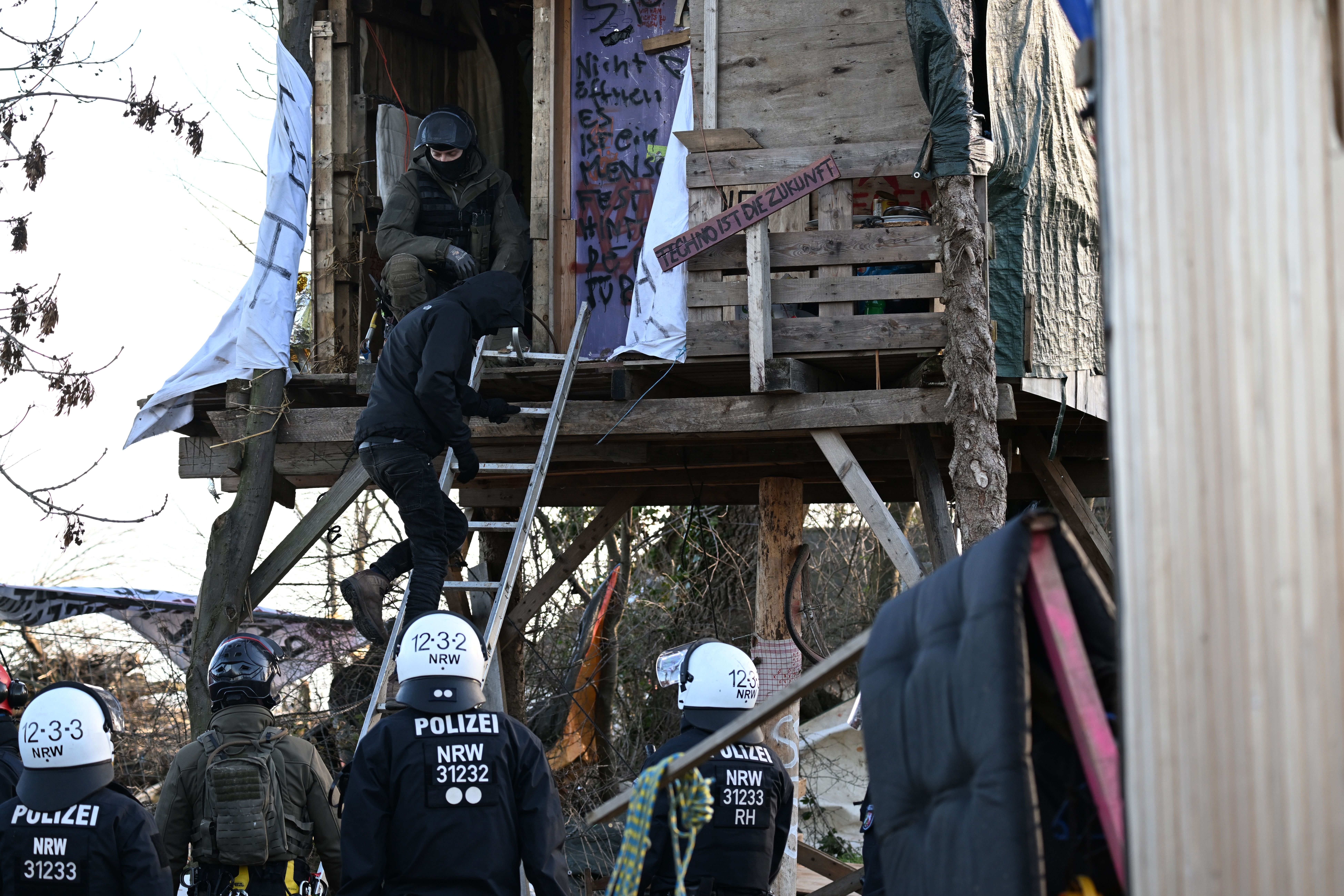 A climate activist leaves a tree house in Lützerath after it was opened by German police Jan. 15.