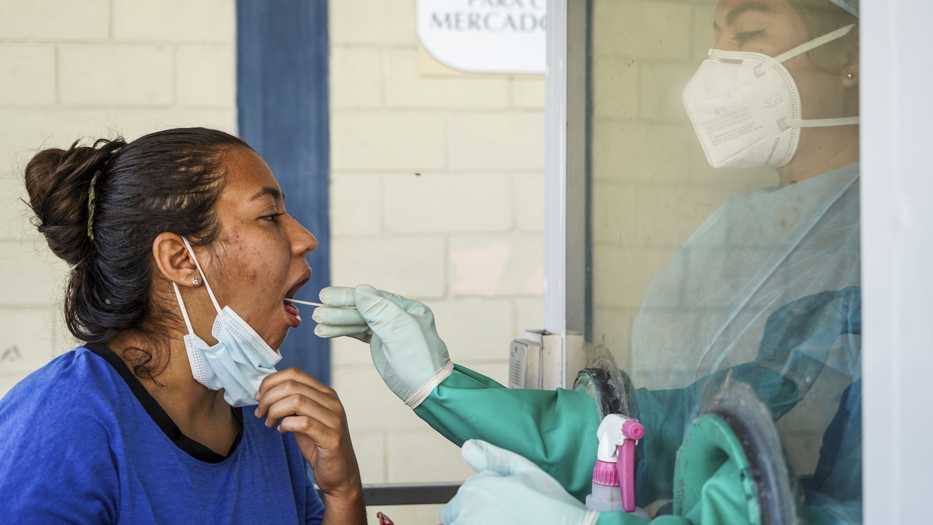 A health worker taking a swab sample from a patient at a COVID-19 testing site in San Salvador, El Salvador.