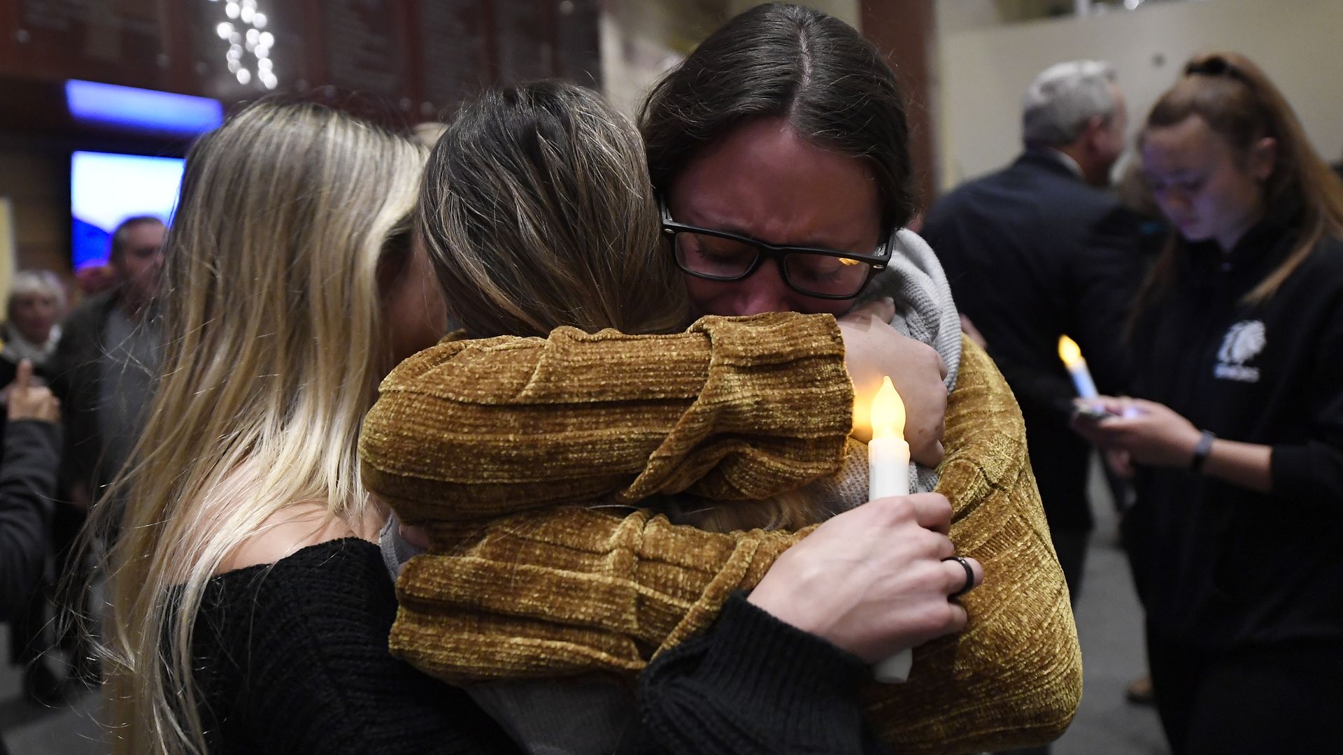 Mourners crying at a candle light vigil after the Thousand Oaks shooting