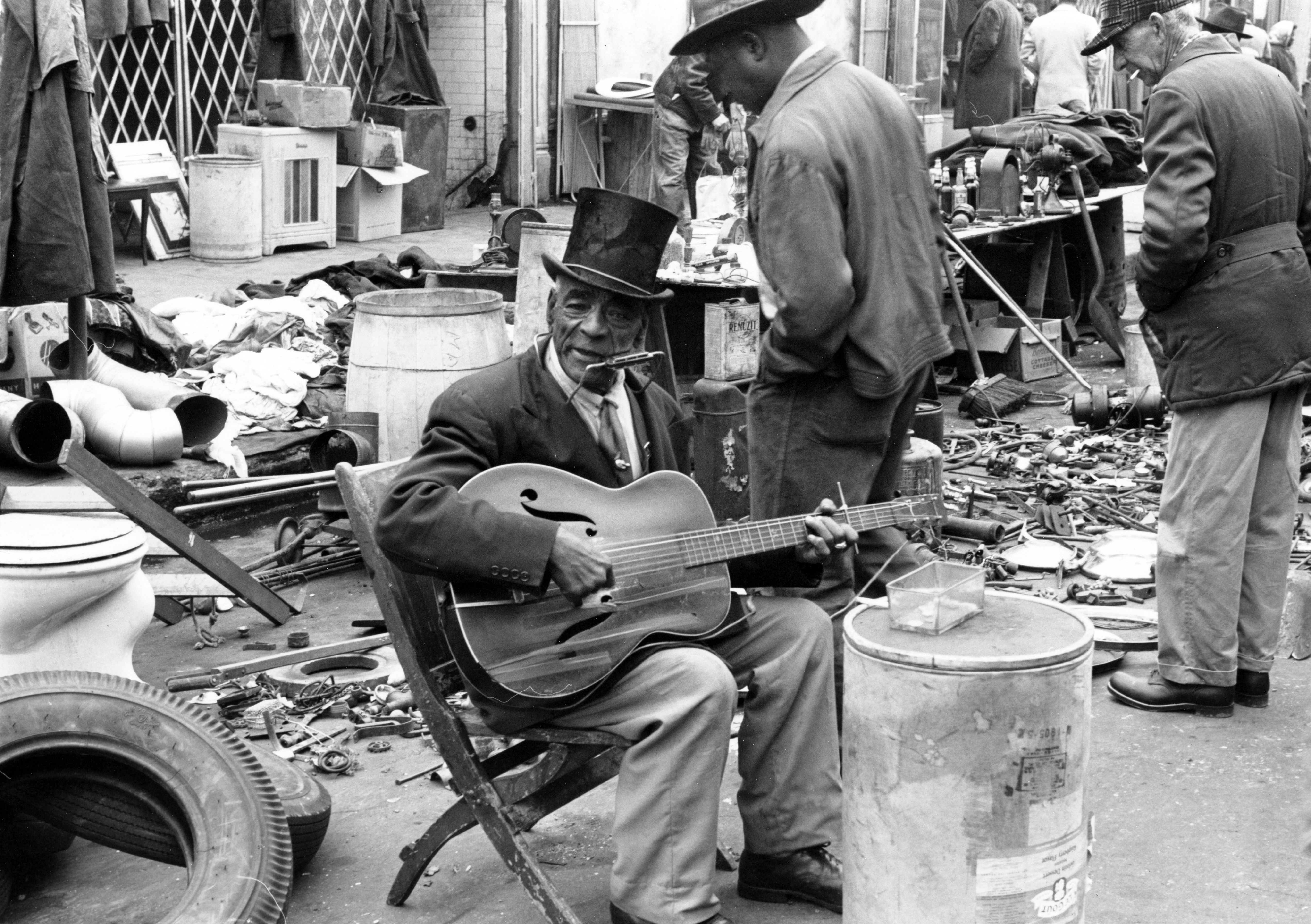 black and white photo of a man playing guitar