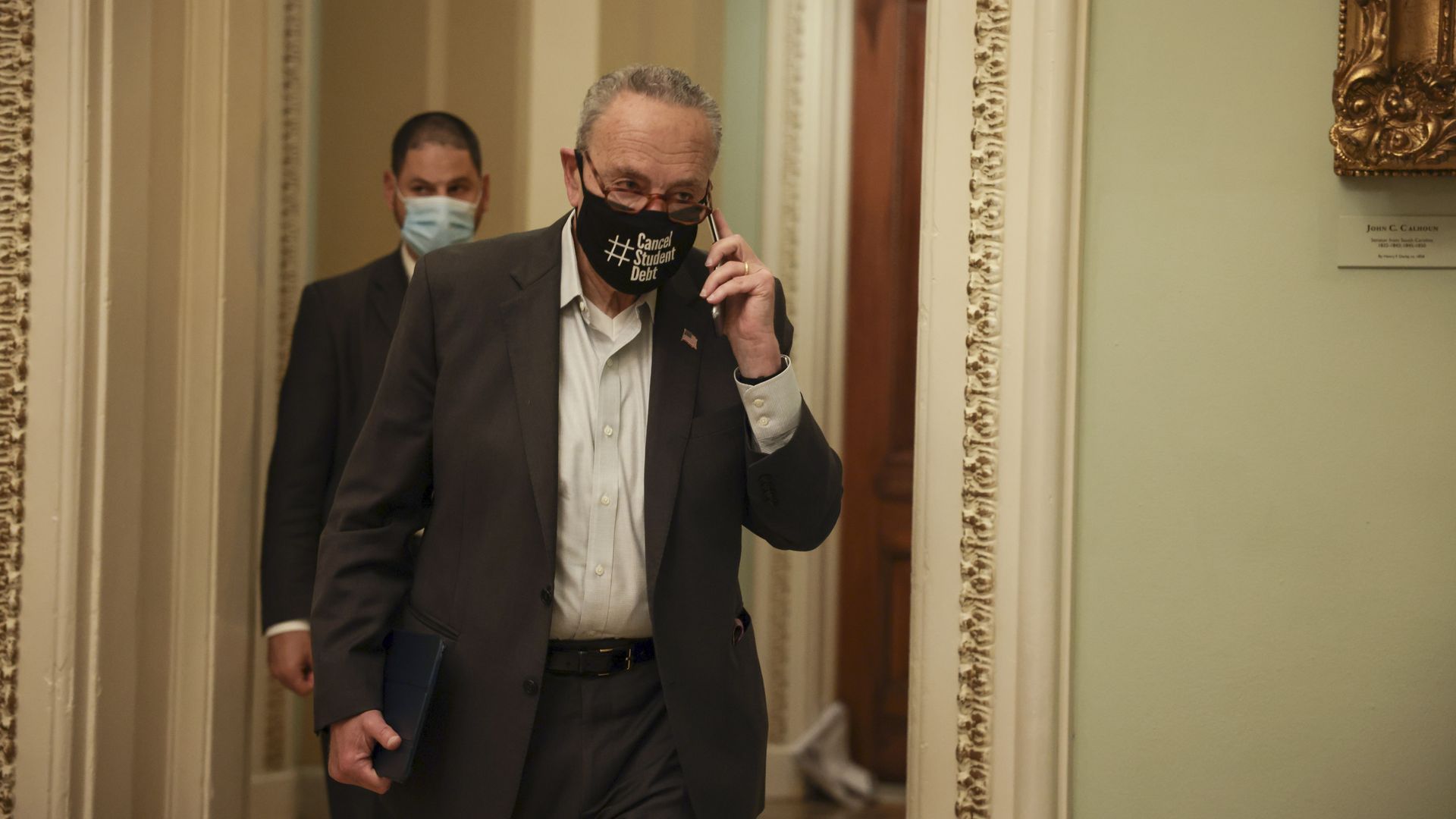 Senate Majority Leader Chuck Schumer (D-NY) speaks on the phone as he arrives on Capitol Hill on October 06, 2021