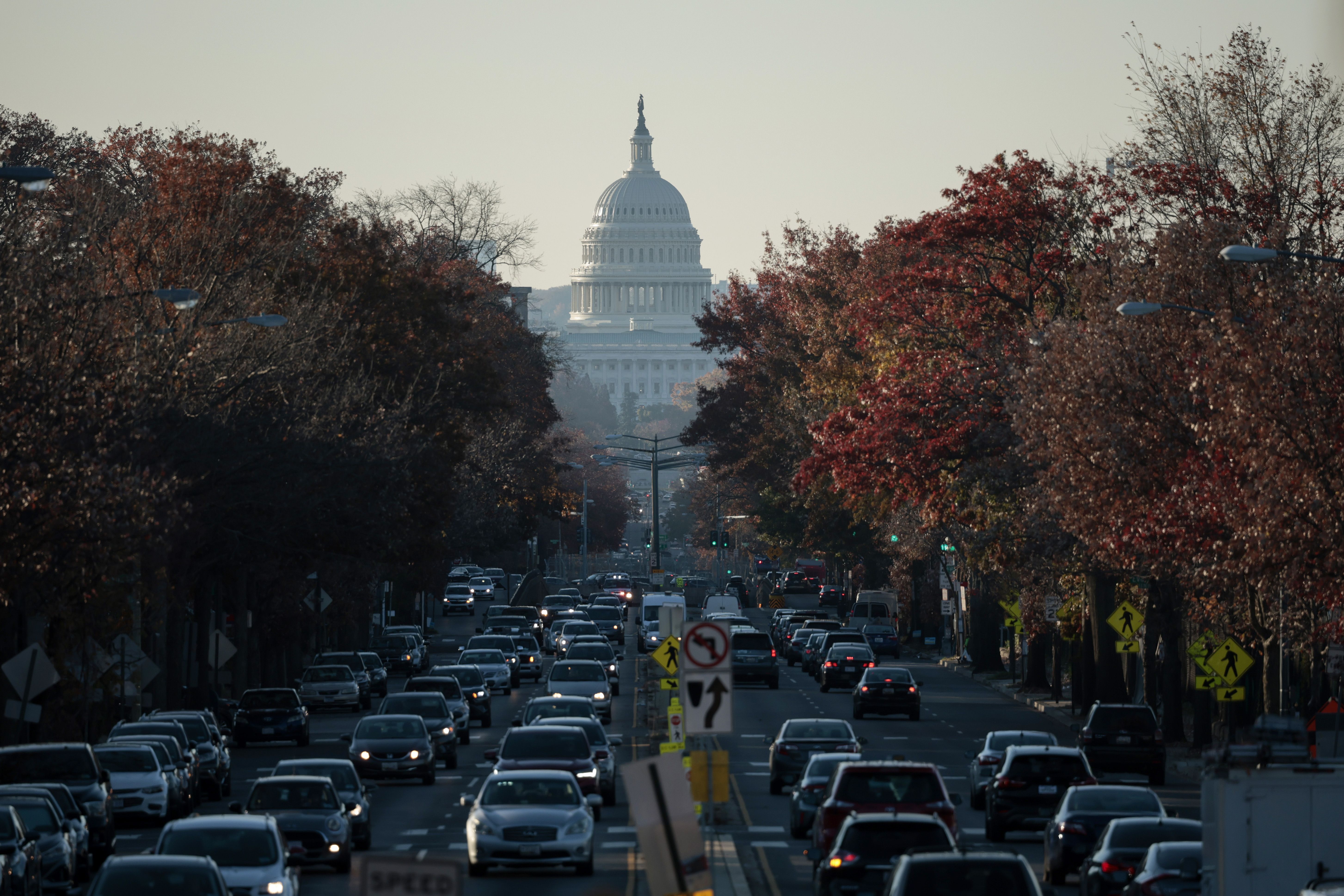 Photo of the U.S. Capitol building in the distance, with roads leading to and from crammed with cars