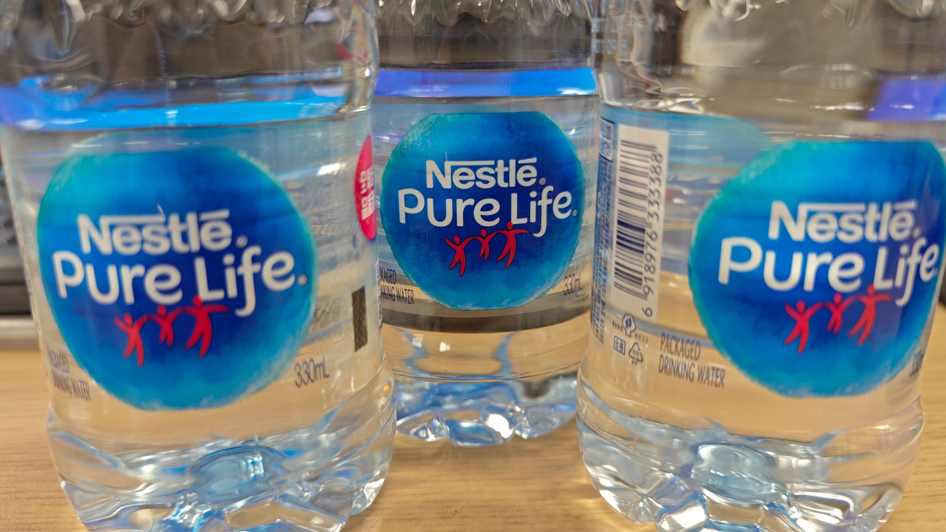 Clear plastic bottles of Nestle-branded Pure Life water.