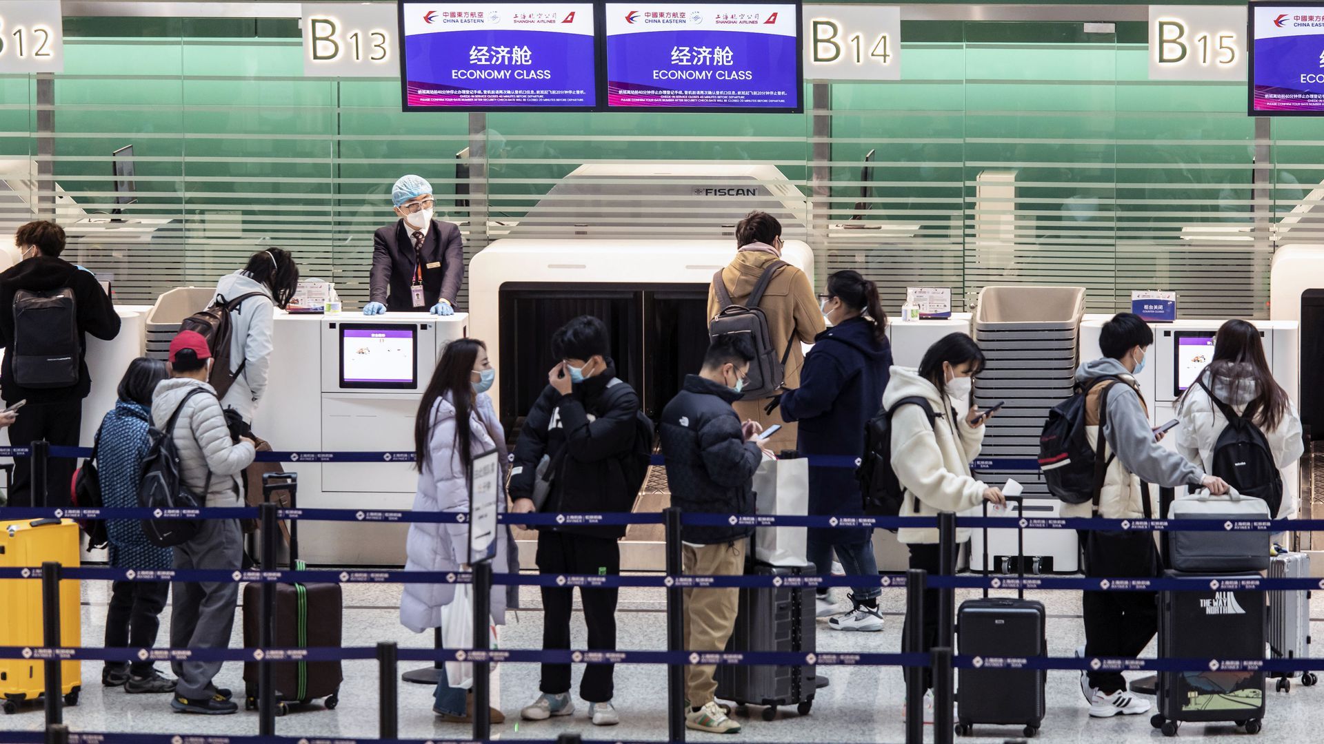 Travelers check in for a flight at the Hongqiao International Airport in Shanghai, China, on Dec. 12, 2022