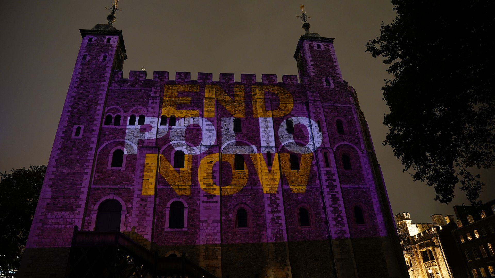 The Tower of London is lit up purple with the slogan 'End Polio Now' in 2021.