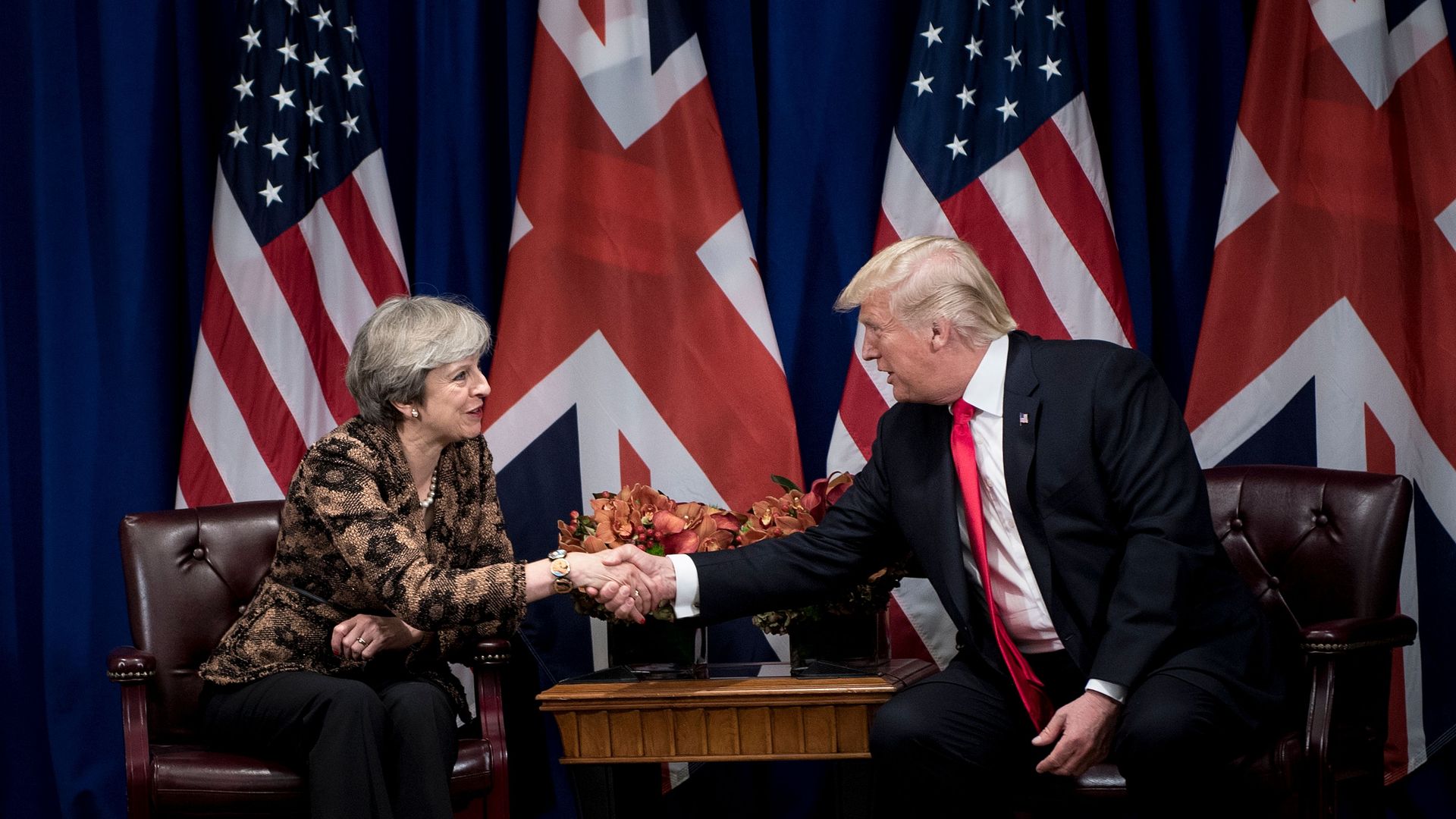 Theresa May and Donald Trump shaking hands. 