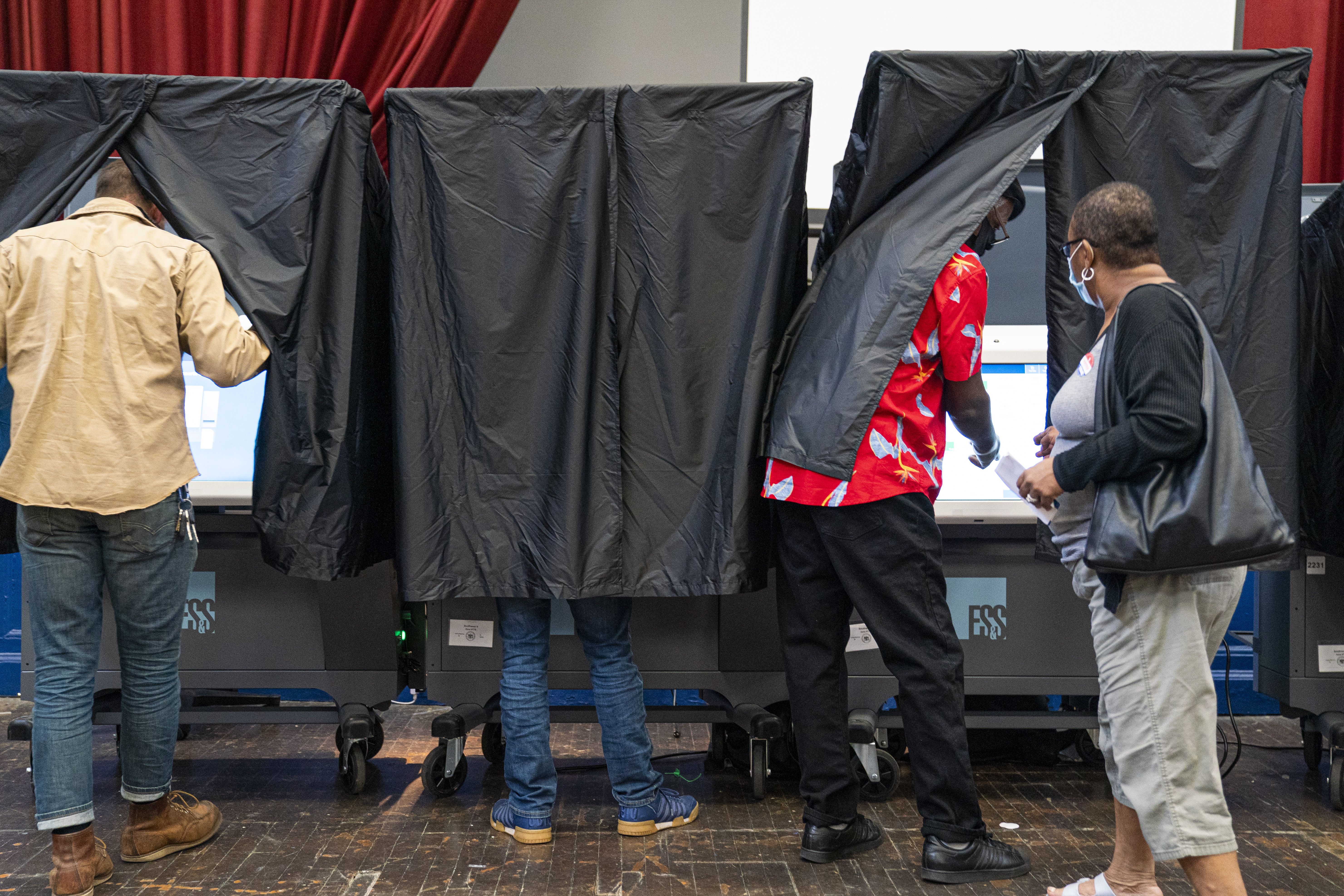 Voters line up inside voting booths