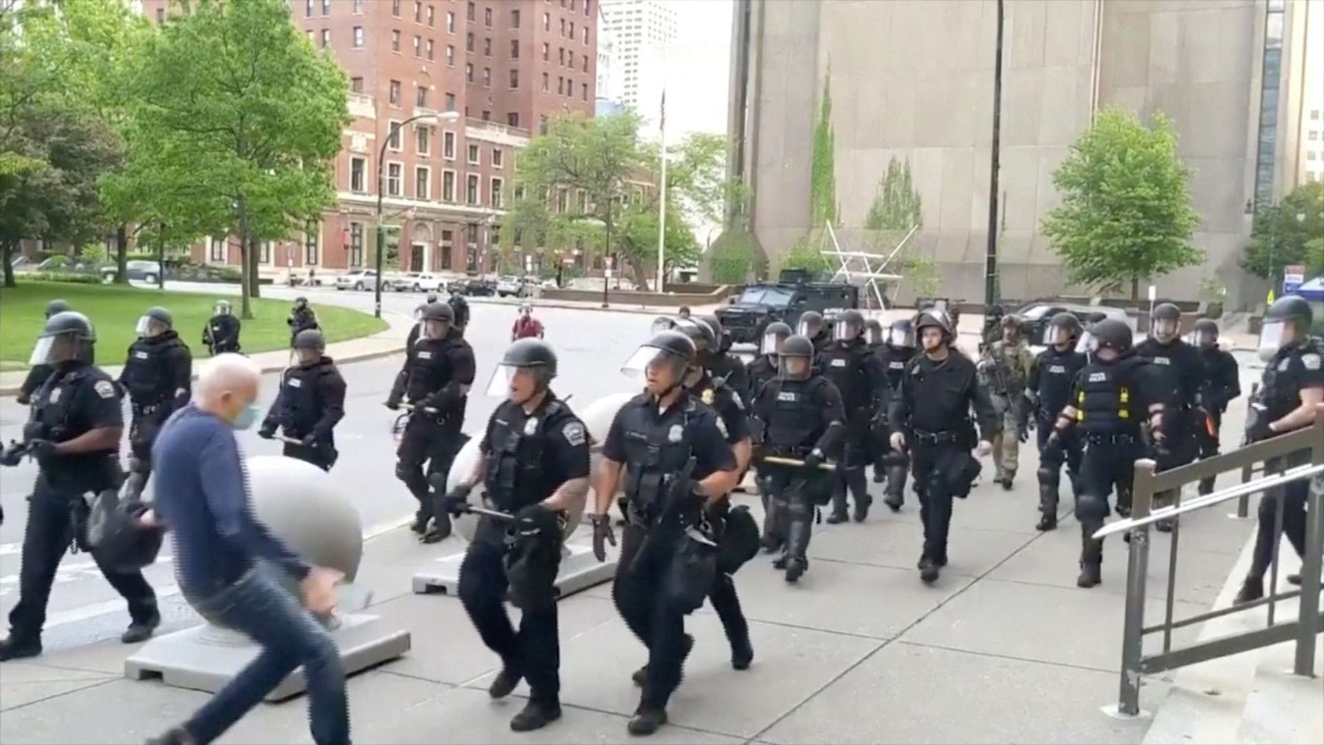 Elderly man falling after being pushed by police