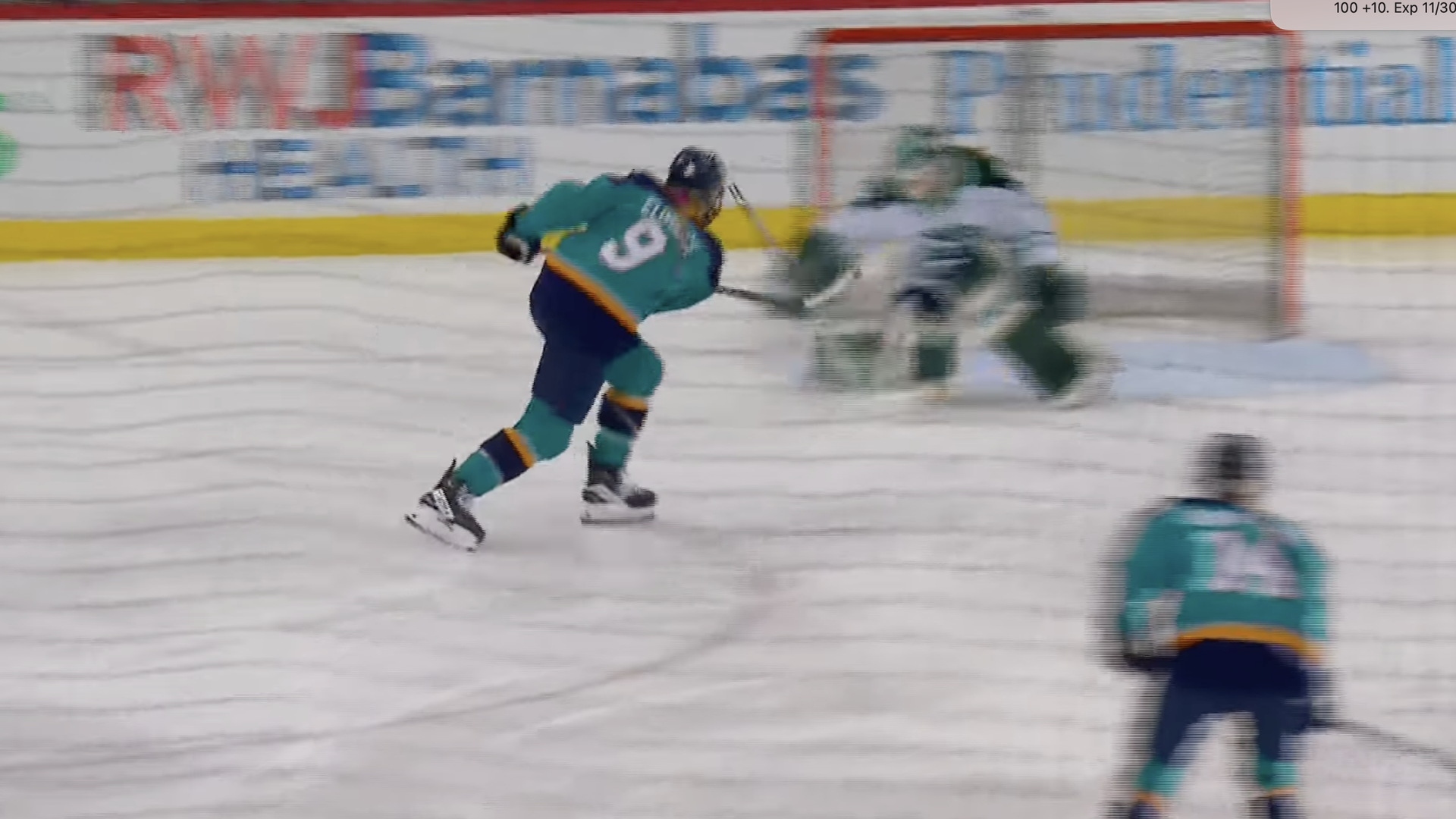 Female ice hockey players skating on a rink during a game