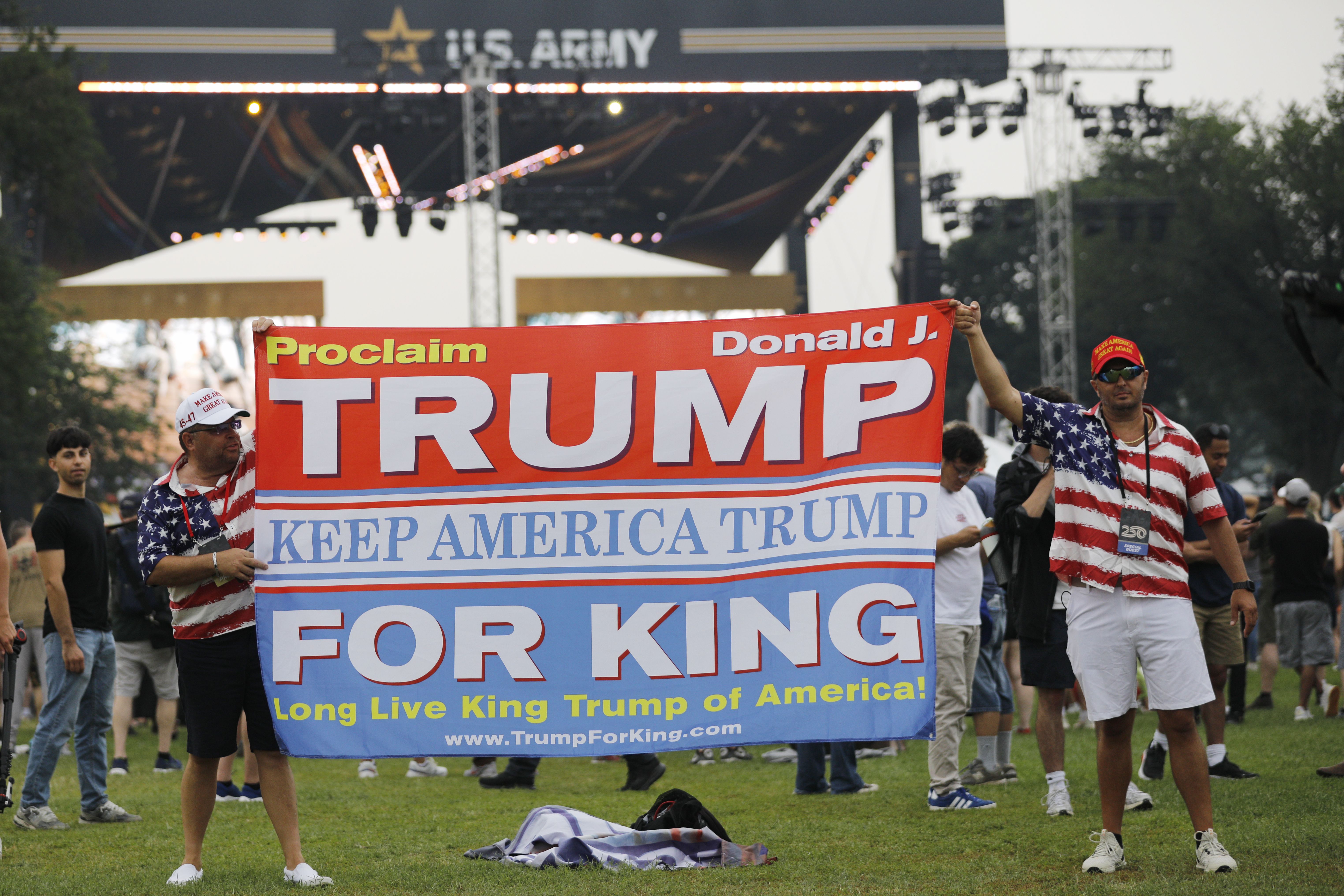 Two men hold up a "Proclaim Donald J Trump For King" banner