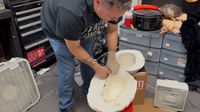 A gif of a mask being pulled out of a mold