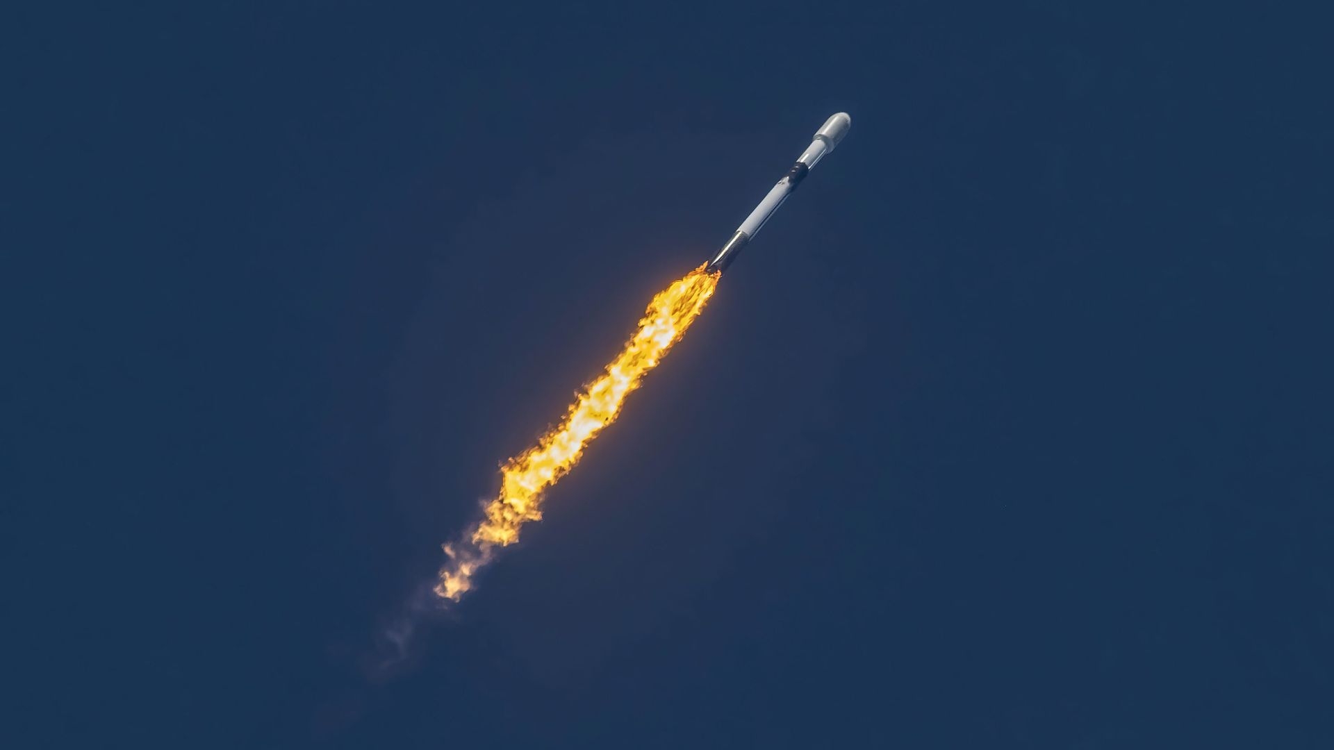 A Falcon 9 rocket carrying Starlink satellites to orbit