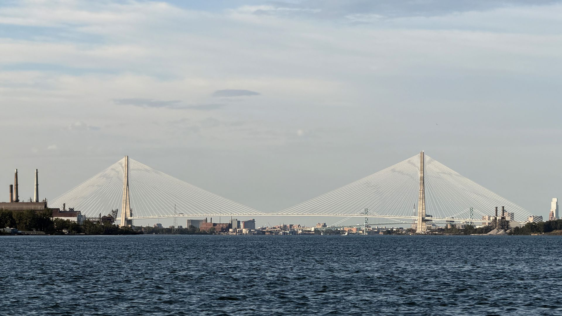 A photo of the Gordie Howe bridge with the Detroit River in front of it