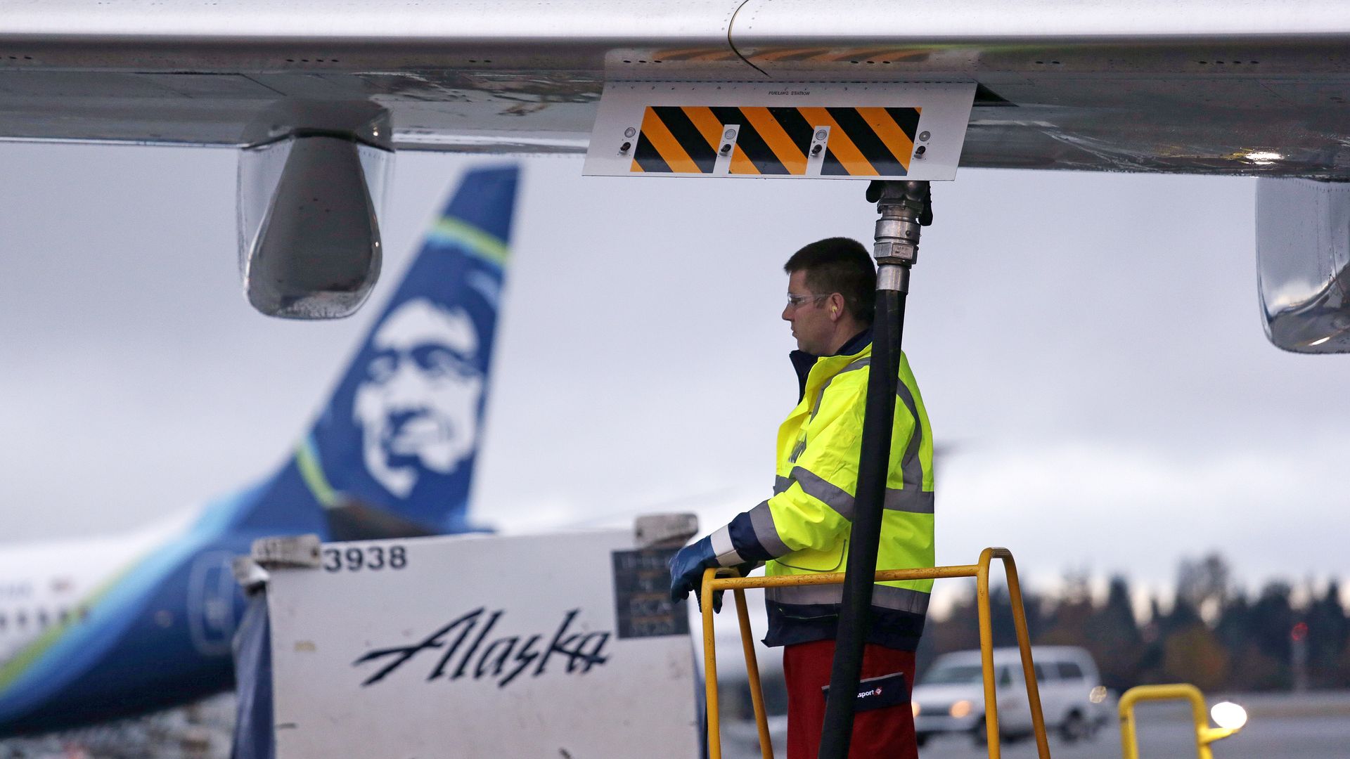 Fueling manager Jarid Svraka looks on as he fuels an Alaska Airlines Boeing 737-800 jet with a new, blended alternative jet fuel. 