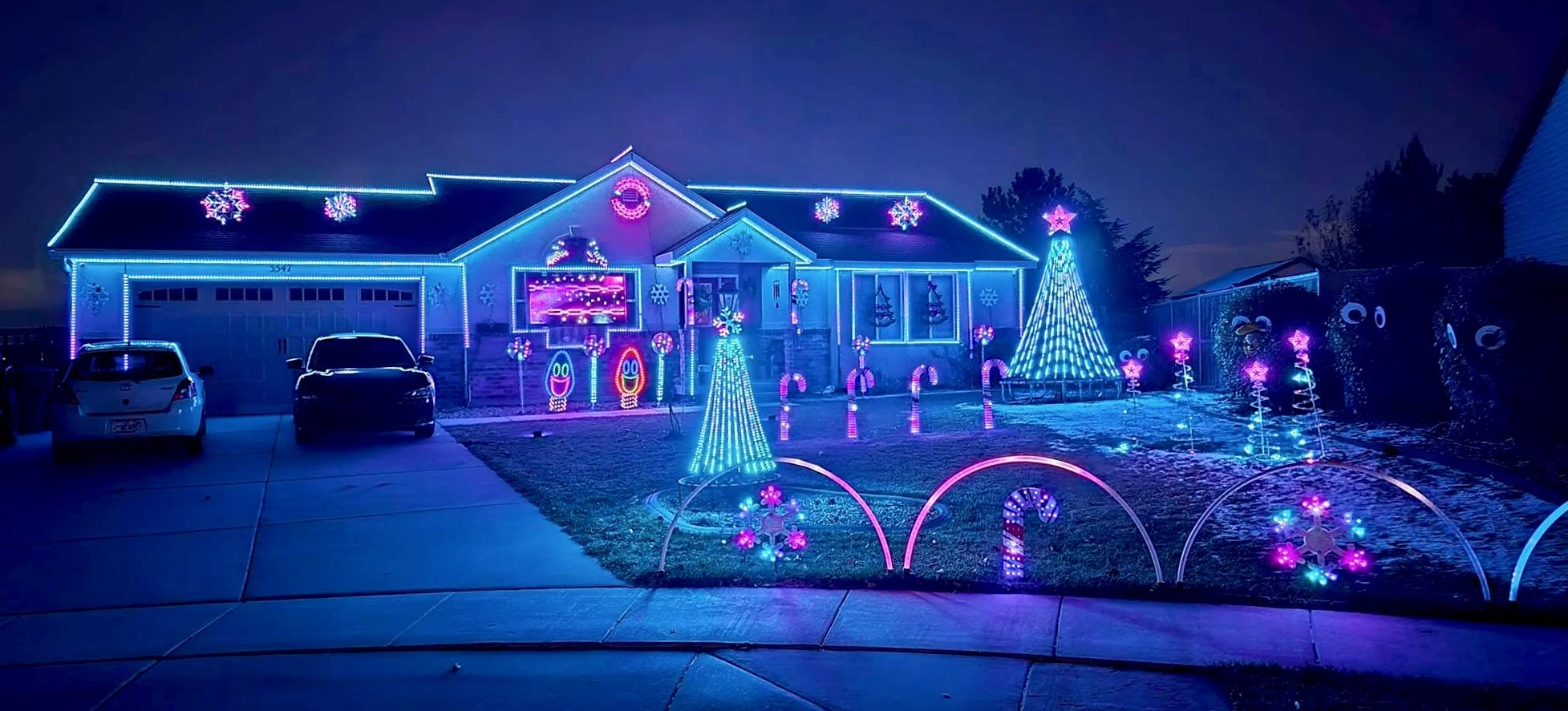 Blue and rainbow Christmas lights on a house.