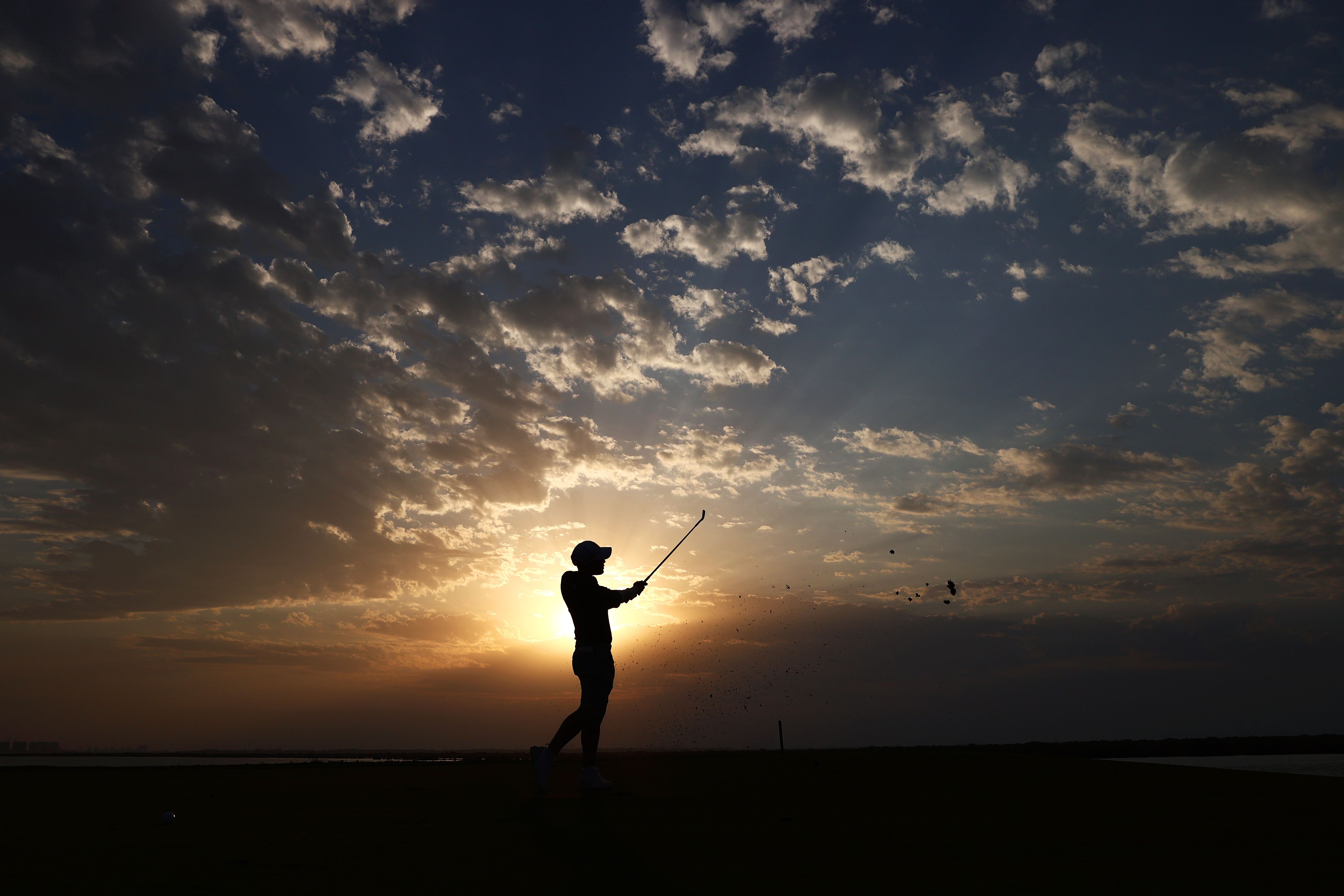 Golfer with sun behind him
