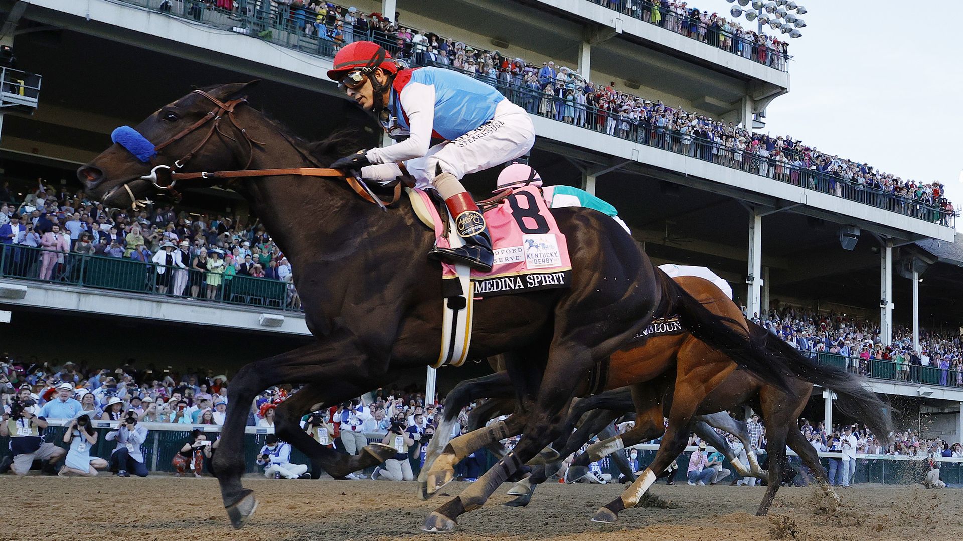 Medina Spirit #8, ridden by jockey John Velazquez, (R) crosses the finish line to win the 147th running of the Kentucky Derby at Churchill Downs on May 01, 2021 in Louisville, Kentucky. 
