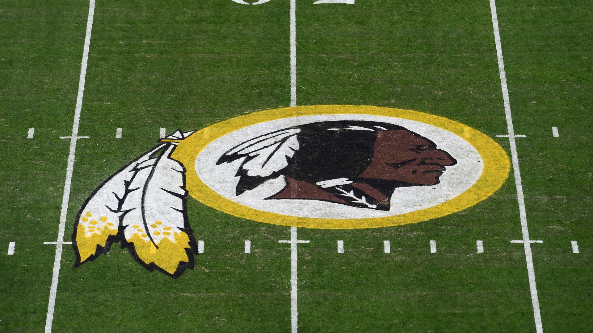 NFL team Redskin's logo on a football field by the 50-yard line