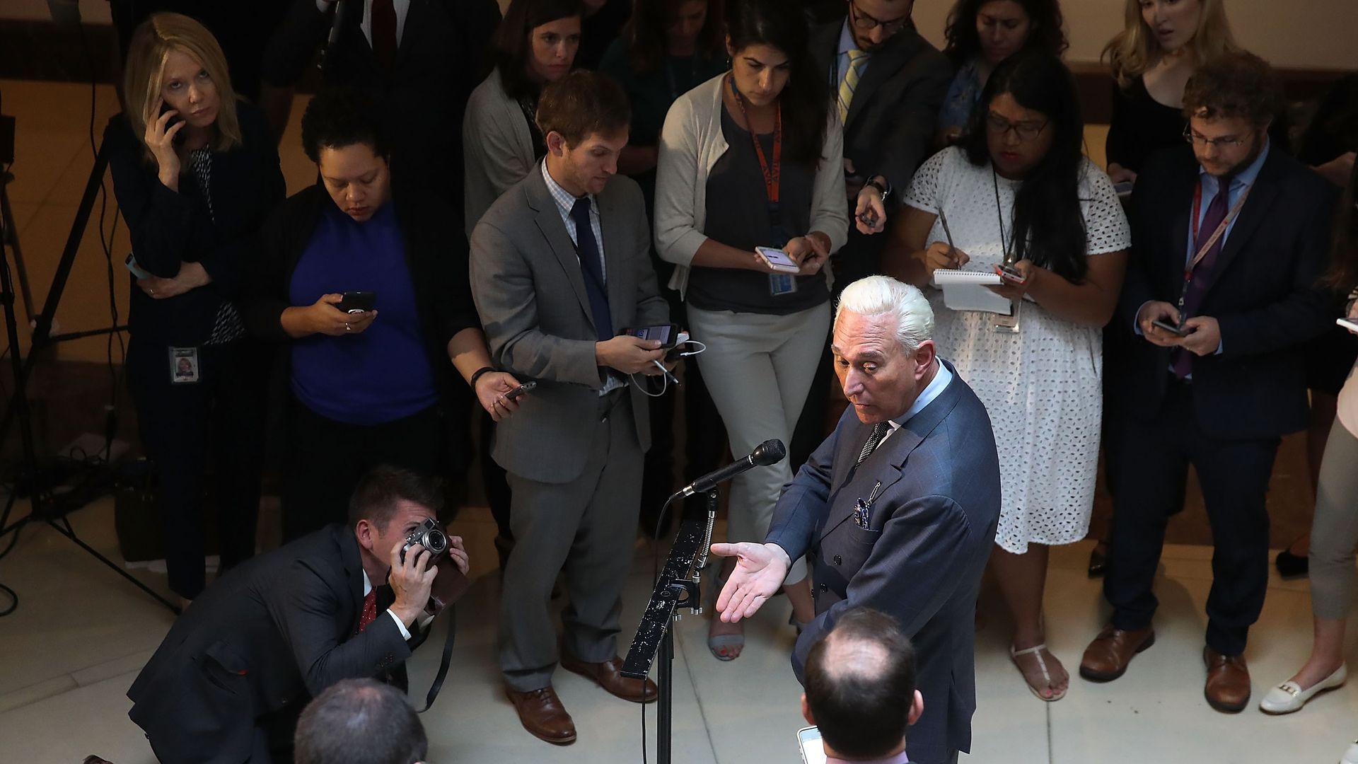 Stone surrounded by reporters at the Capitol