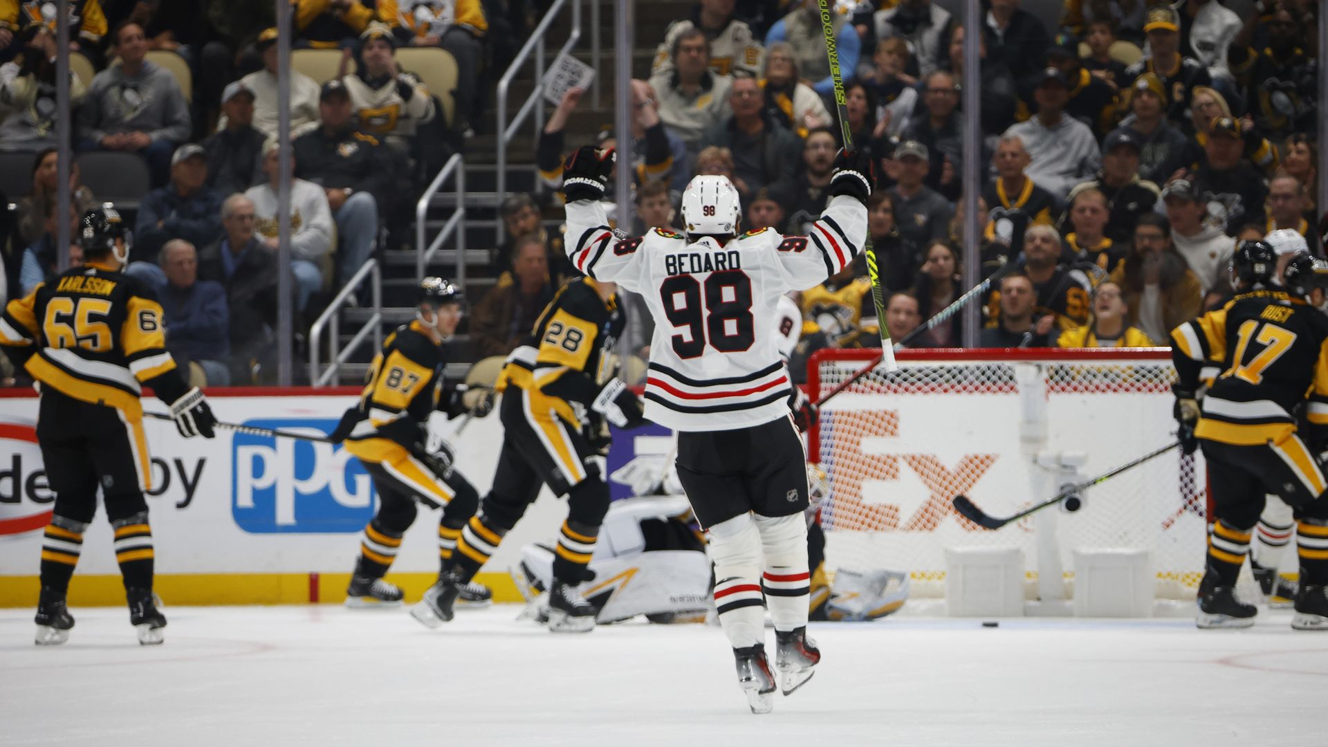 Photo of a hockey player raising his hands in victory 