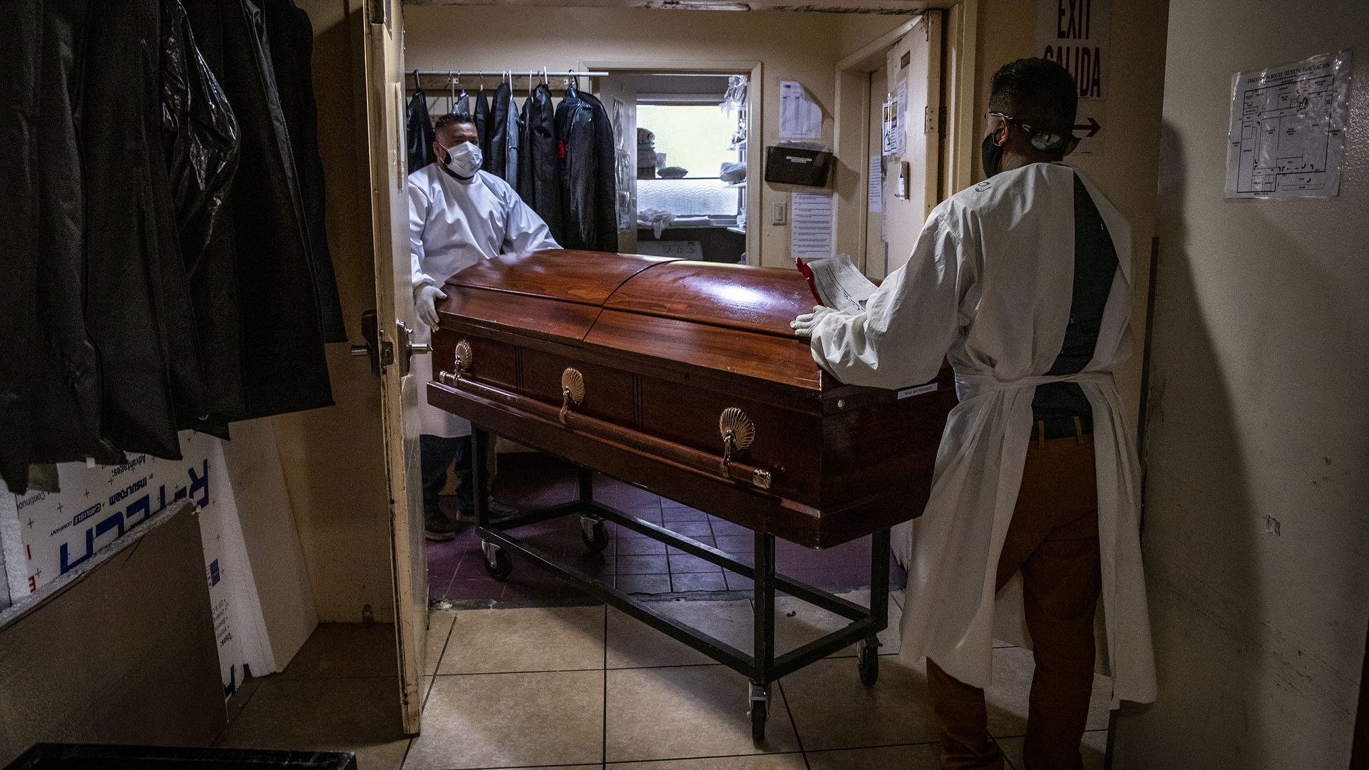 Continental Funeral Home attendants move a casket