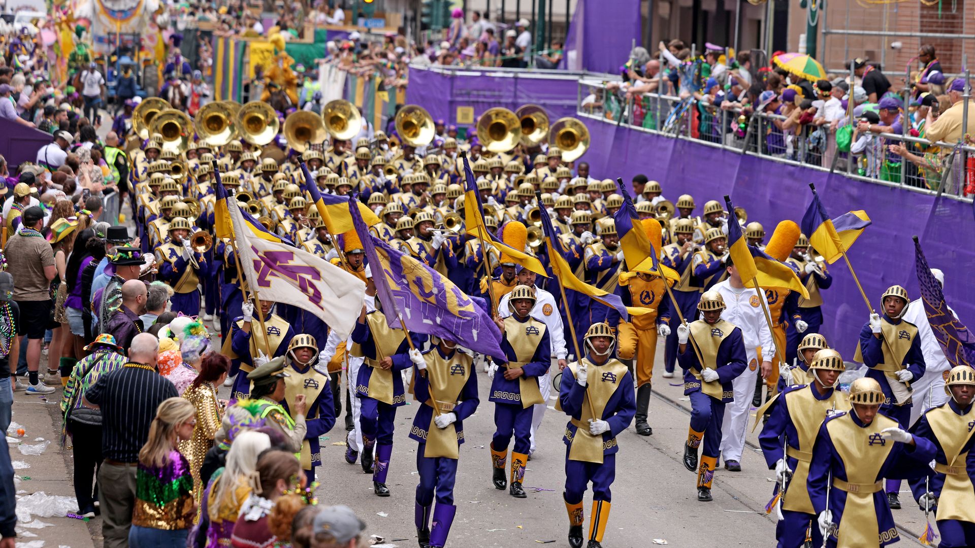 The St. Augustine High School marching band heads down the crowded parade route during the Rex parade on St. Charles Avenue downtown.