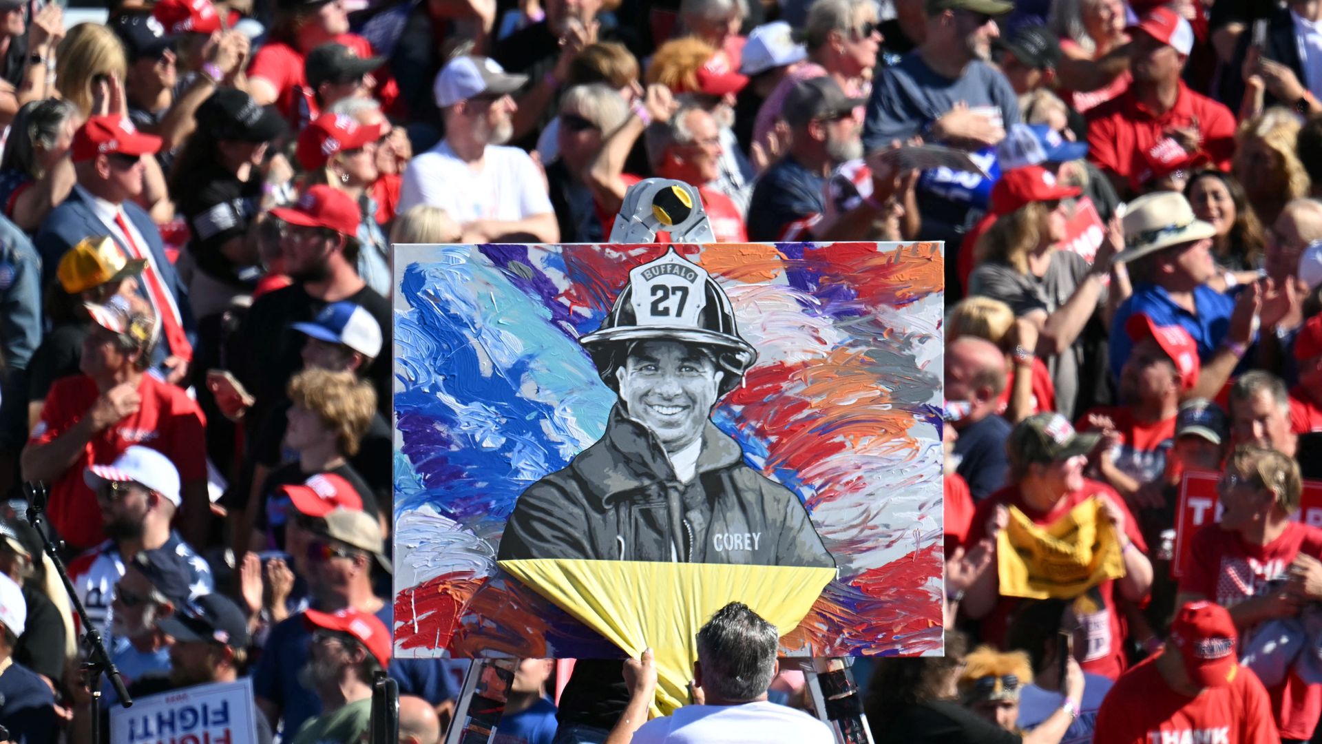An artist reveals a portrait of the man killed at Trump's Butler, PA, rally. In the image, Corey Comperatore is wearing his firefighter uniform.