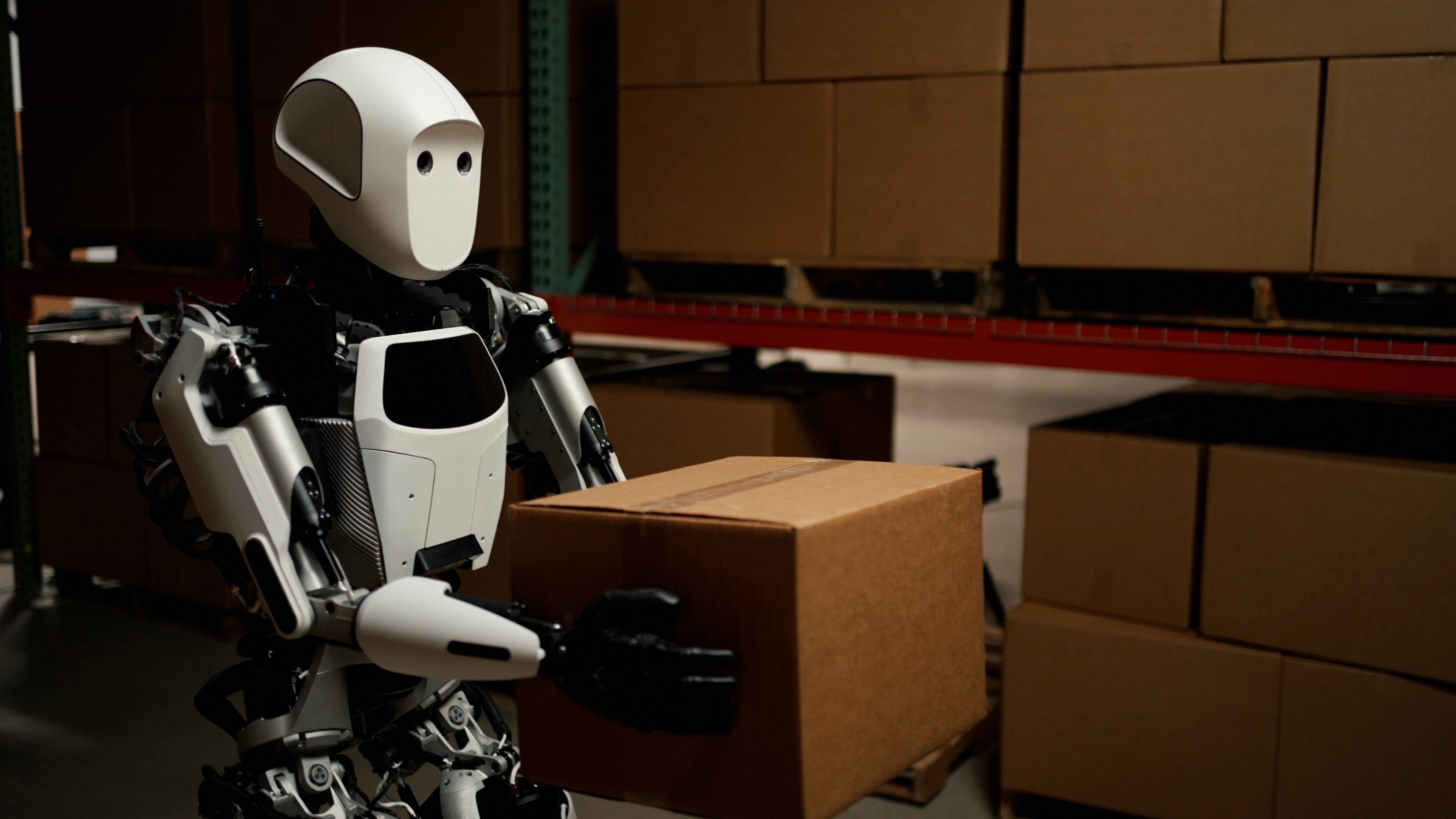 A humanoid robot carrying a box.