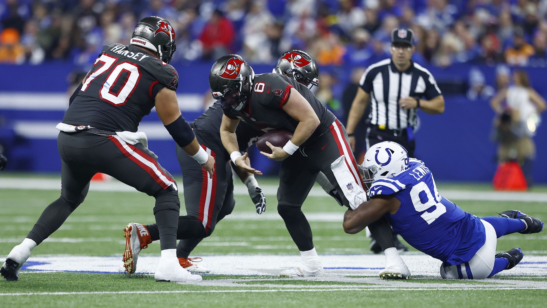 Indianapolis Colts defensive end Tyquan Lewis (94) sacks Tampa Bay Buccaneers quarterback Baker Mayfield (6) during an NFL game between the Tampa Bay Buccaneers and the Indianapolis Colts on November 26, 2023 at Lucas Oil Stadium in Indianapolis.
