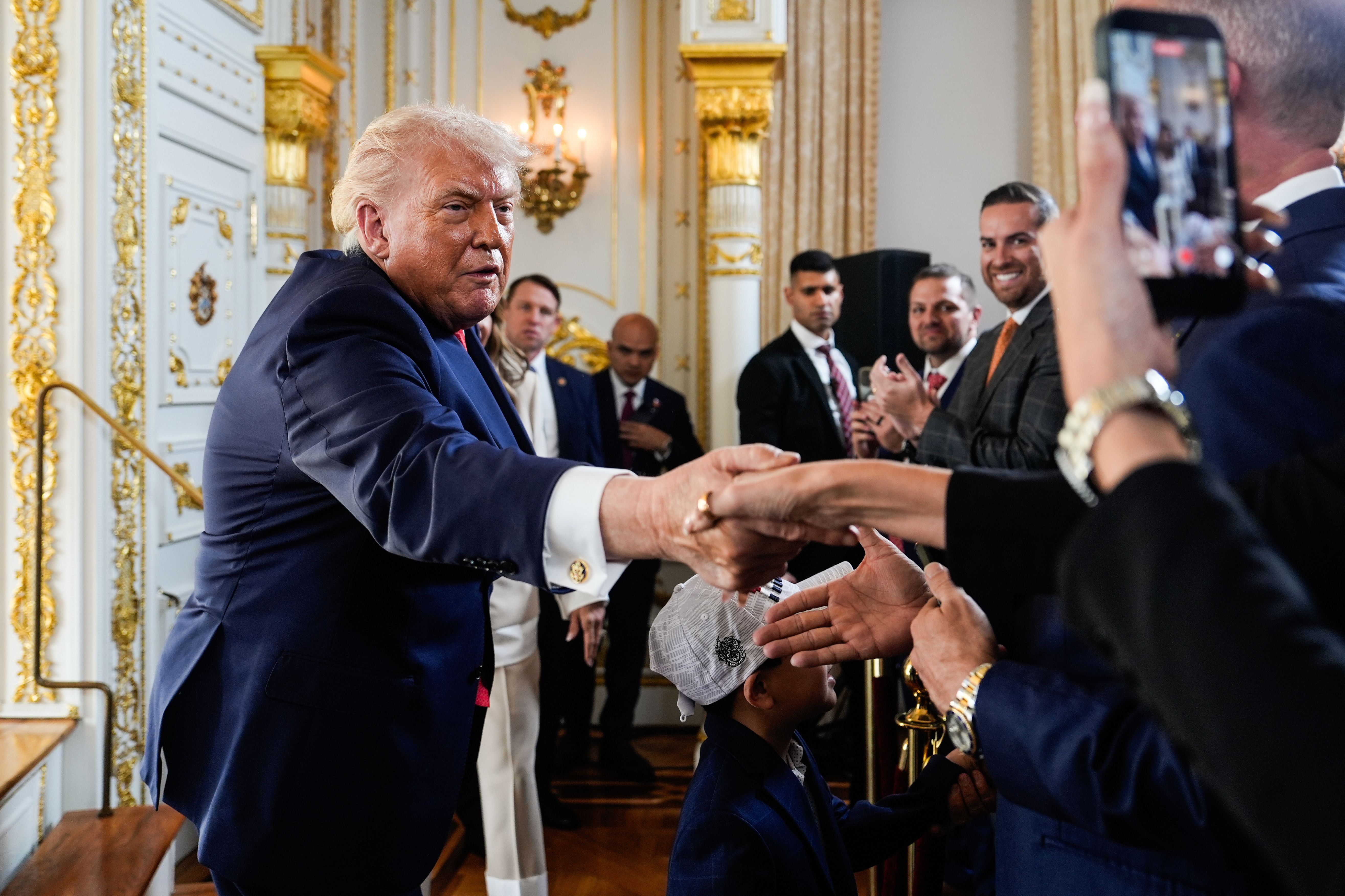 President Trump shakes hands with supporters after a  Mar-a-Lago ceremony on Friday to rename a Palm Beach road "President Donald J. Trump Boulevard."