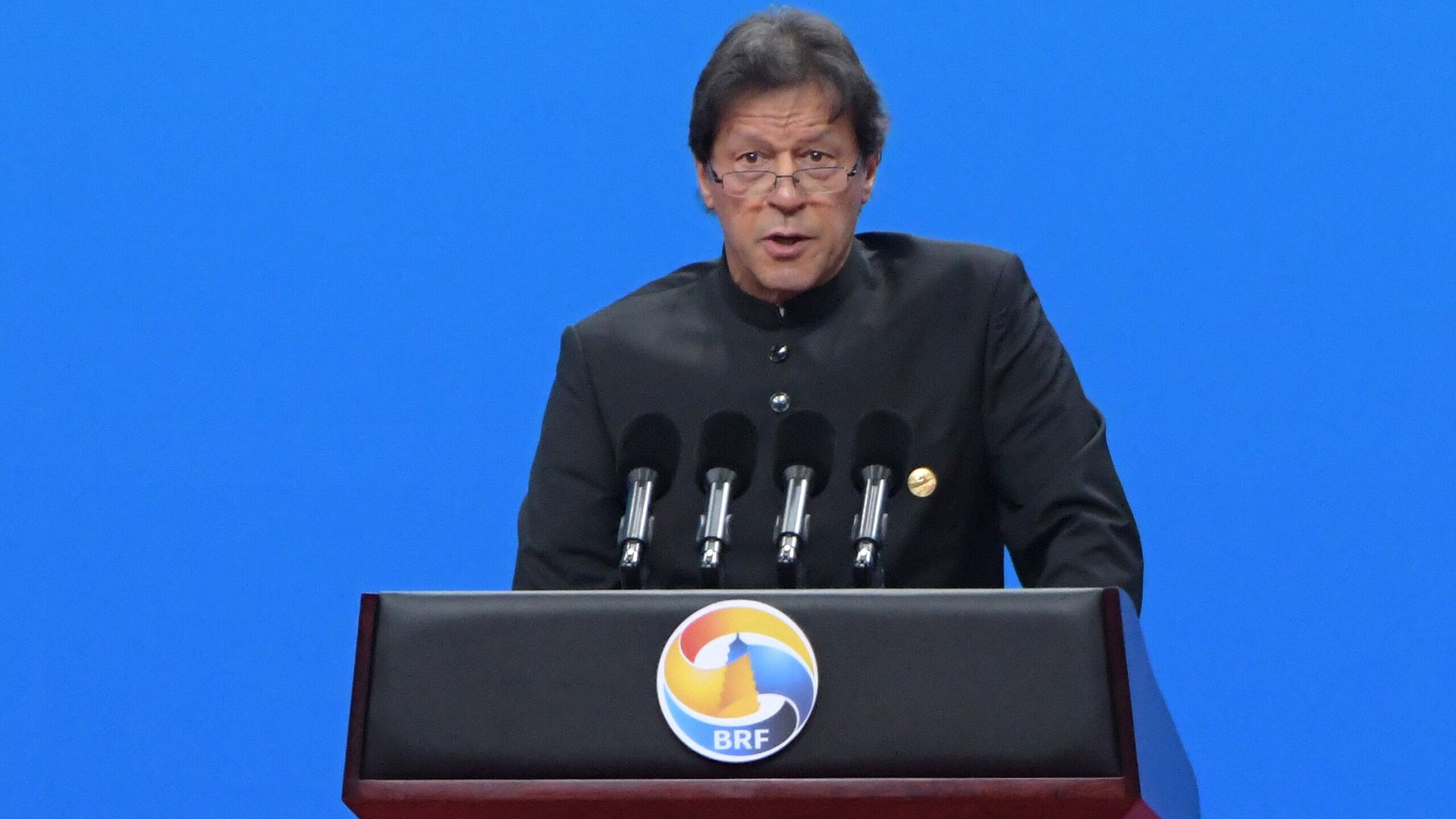 Imran Khan speaking at a lectern