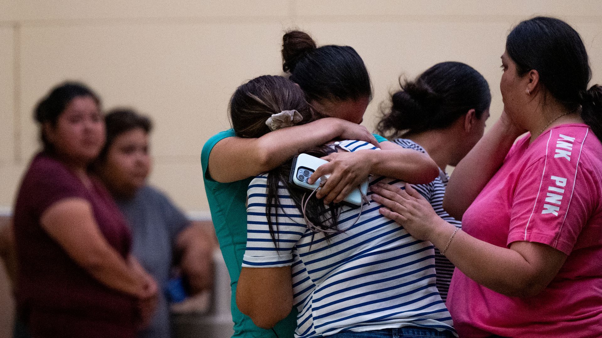 children and parents hugging and crying after the terrible tragedy in Texas on Tuesday