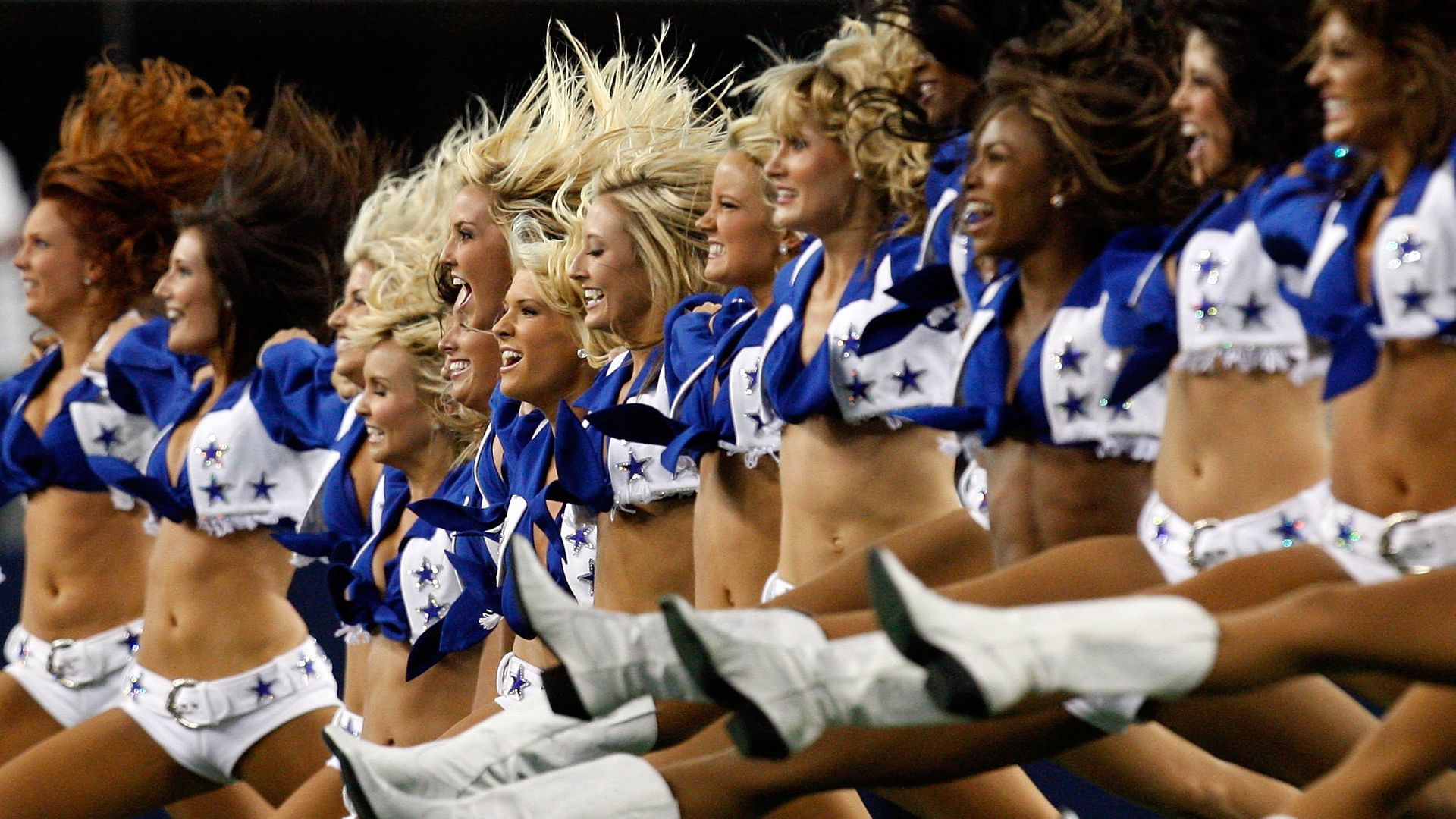Cheerleaders kicking their legs and flailing their hair