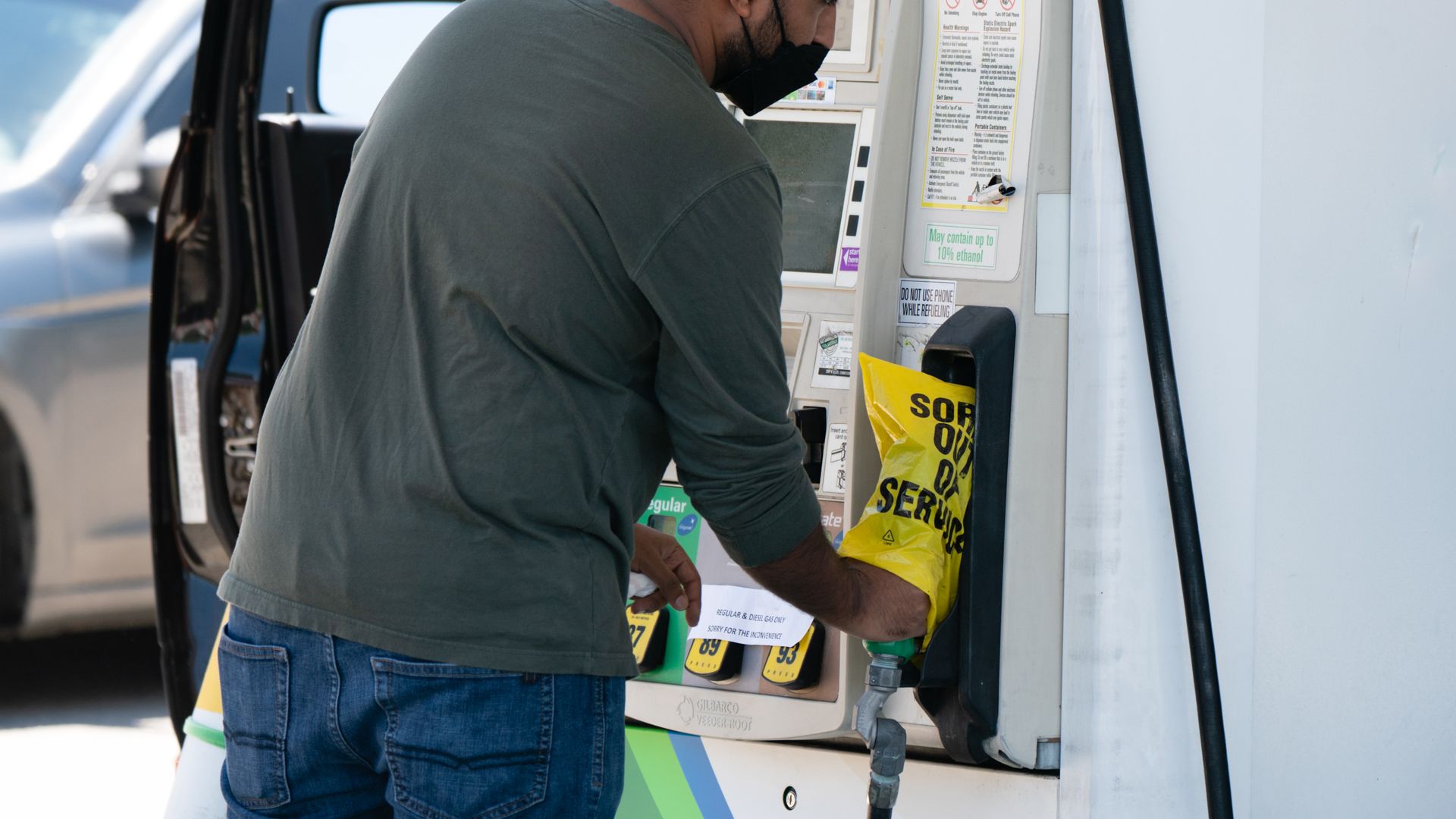 A worker putting an "out of service" bag an empty gas pump in Kennesaw, Georgia, on May 13.