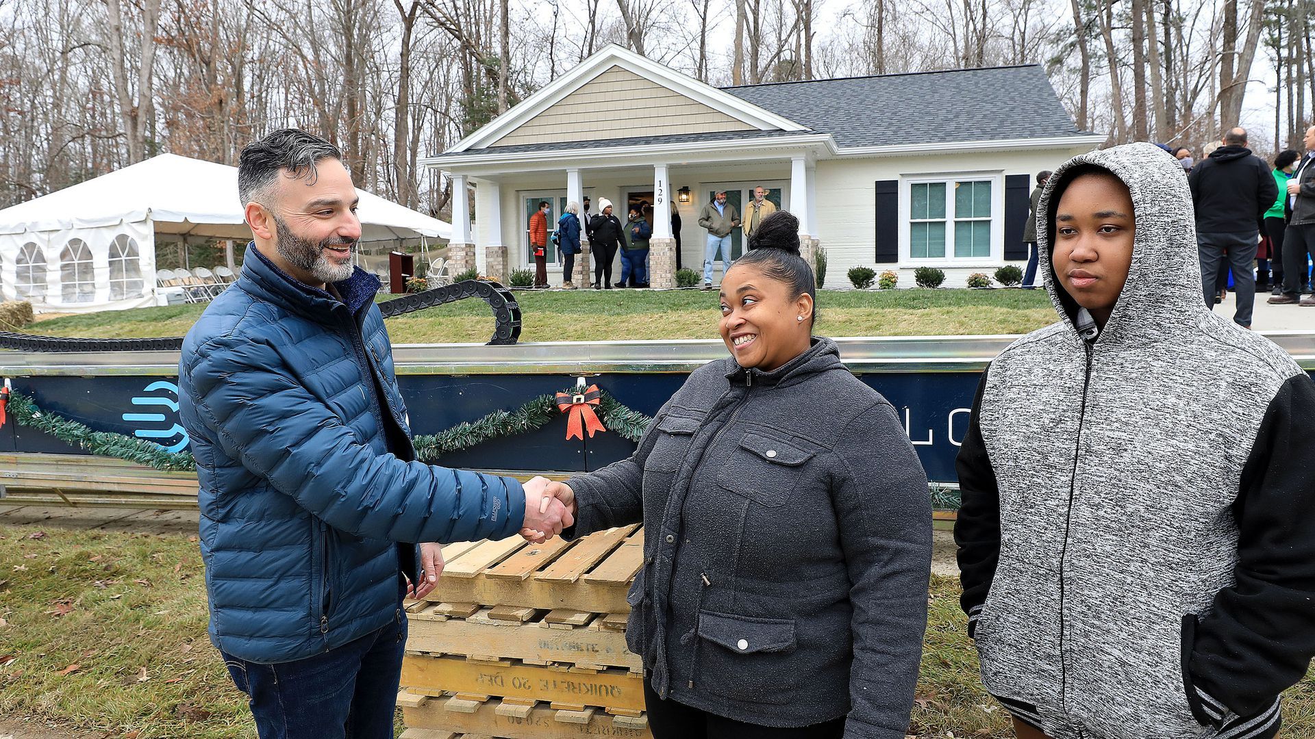 Alquist CEO Zachary Mannheimer with new homeowner April Stringfield and her son.