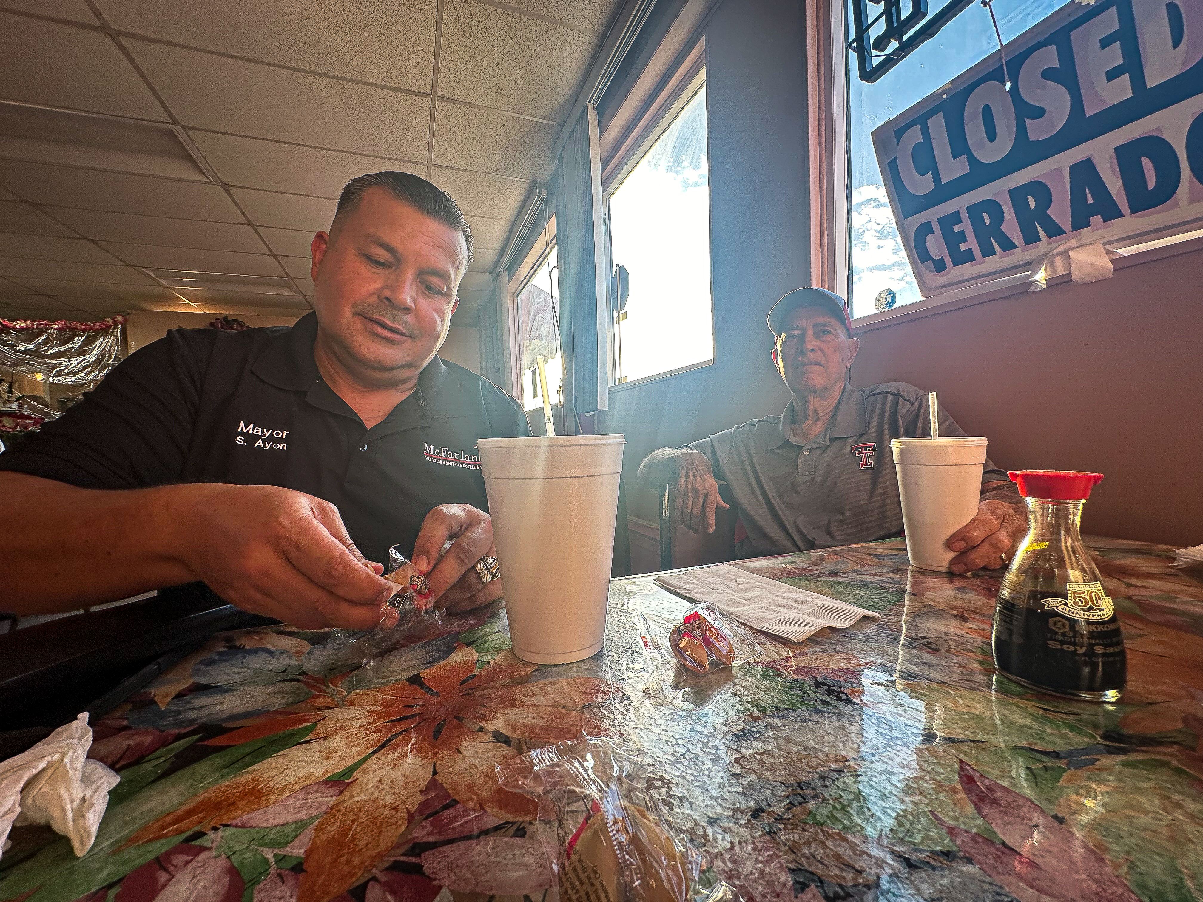 McFarland, California Mayor Saul Ayon eats dinner at the Fay Yin Restaurant with Jim White, the retired cross country coach from the 2015 Disney movie "McFarland, USA."