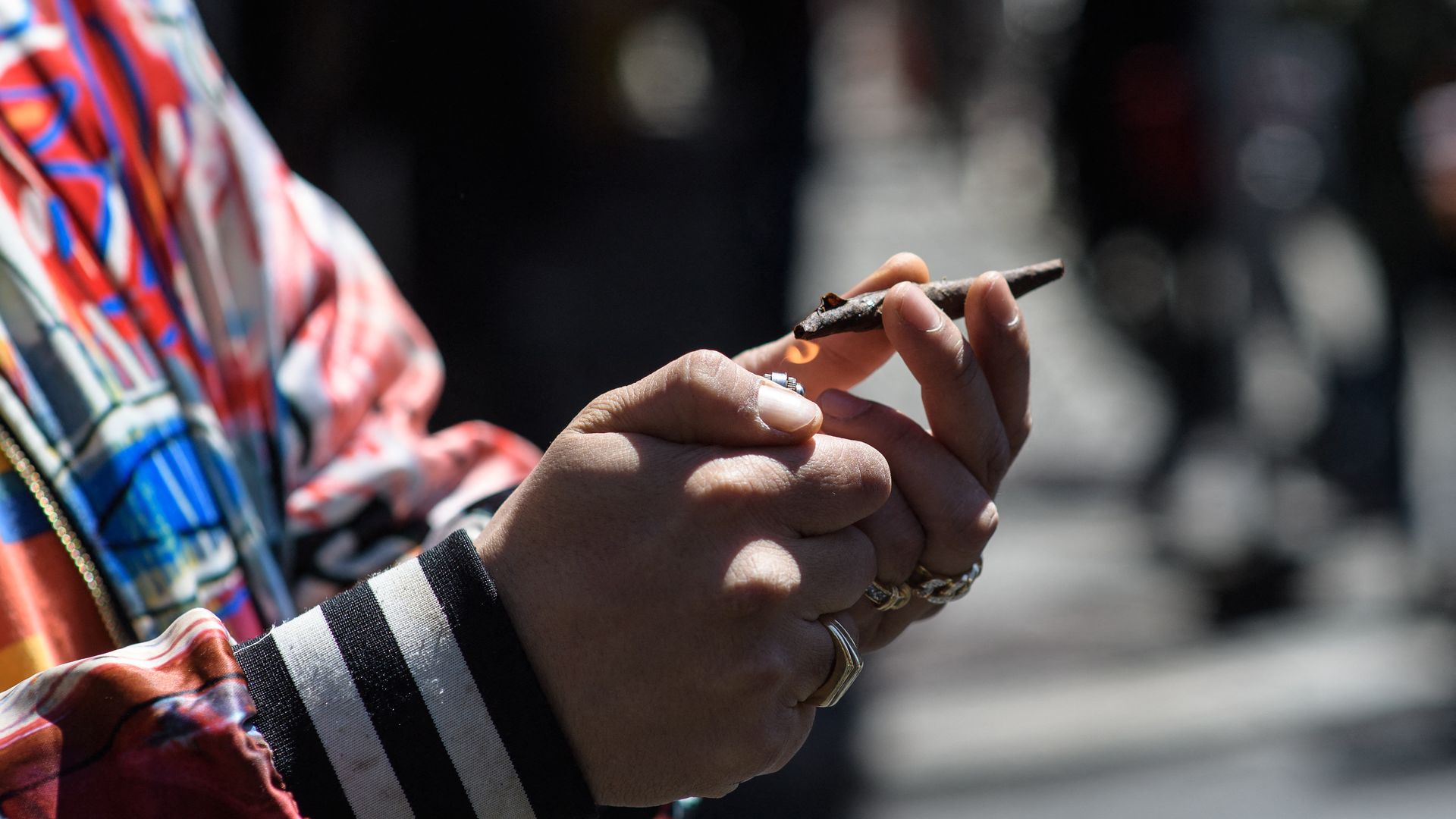 A person smoking a marijuana cigarette in New York City in May May 2021.