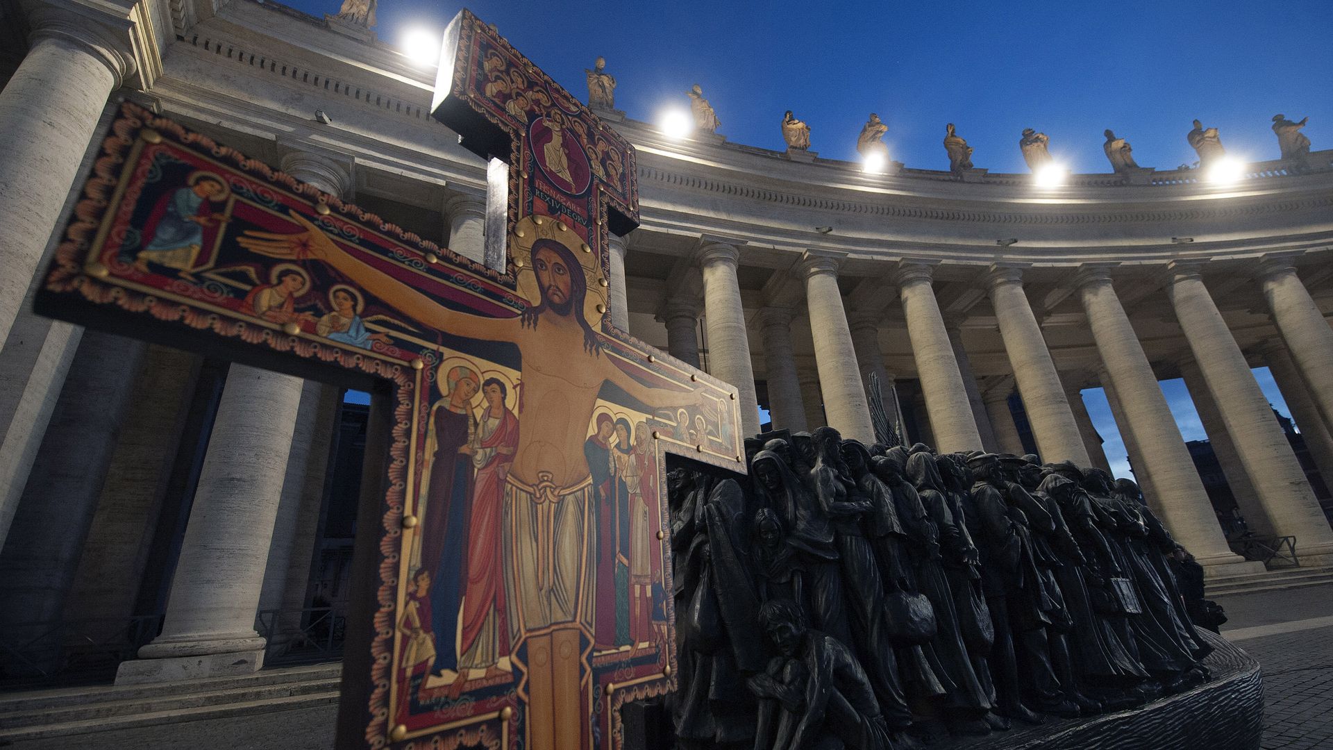 A photo of a cross and a sculpture 